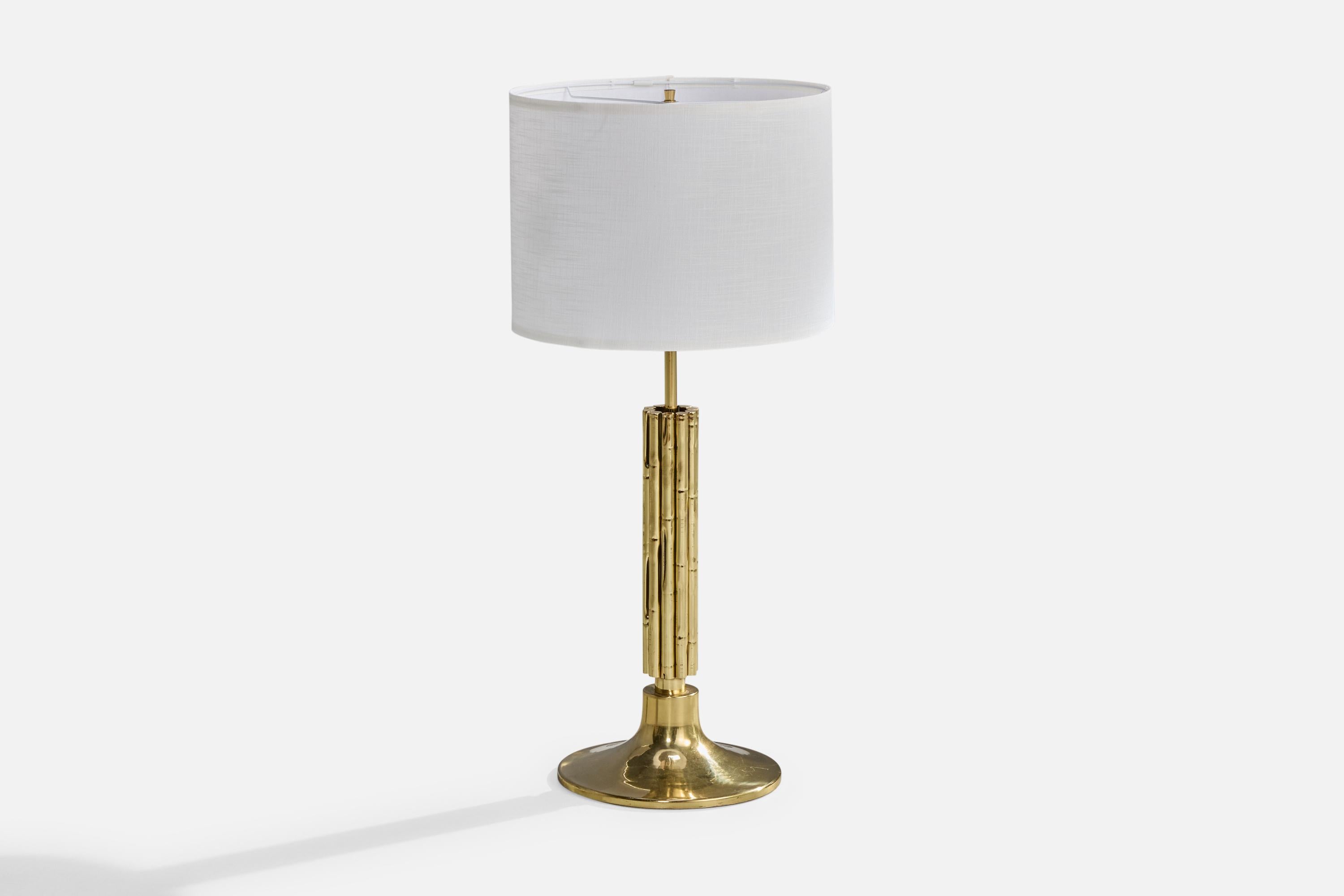 A sizable brass table lamp designed and produced in Italy, c. 1970s.

Dimensions of Lamp (inches): 36.75“ H x 11.75“ Diameter

Dimensions of Shade (inches): 16.25“ Top Diameter x 16.25” Bottom Diameter x 12“ H

Dimensions of Lamp with Shade