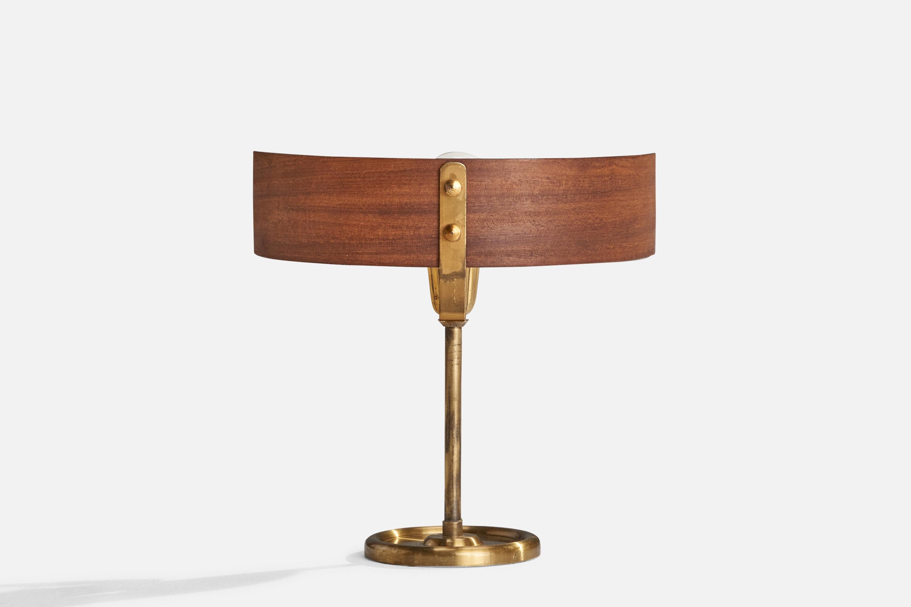 A brass and moulded teak table lamp designed and produced in Italy, c. 1950s.

Overall Dimensions (inches): 9.125” H x 9.375” W x 2.875” D
Stated dimensions include shade.
Bulb Specifications: E-14 Bulb
Number of Sockets: 1
All lighting will be