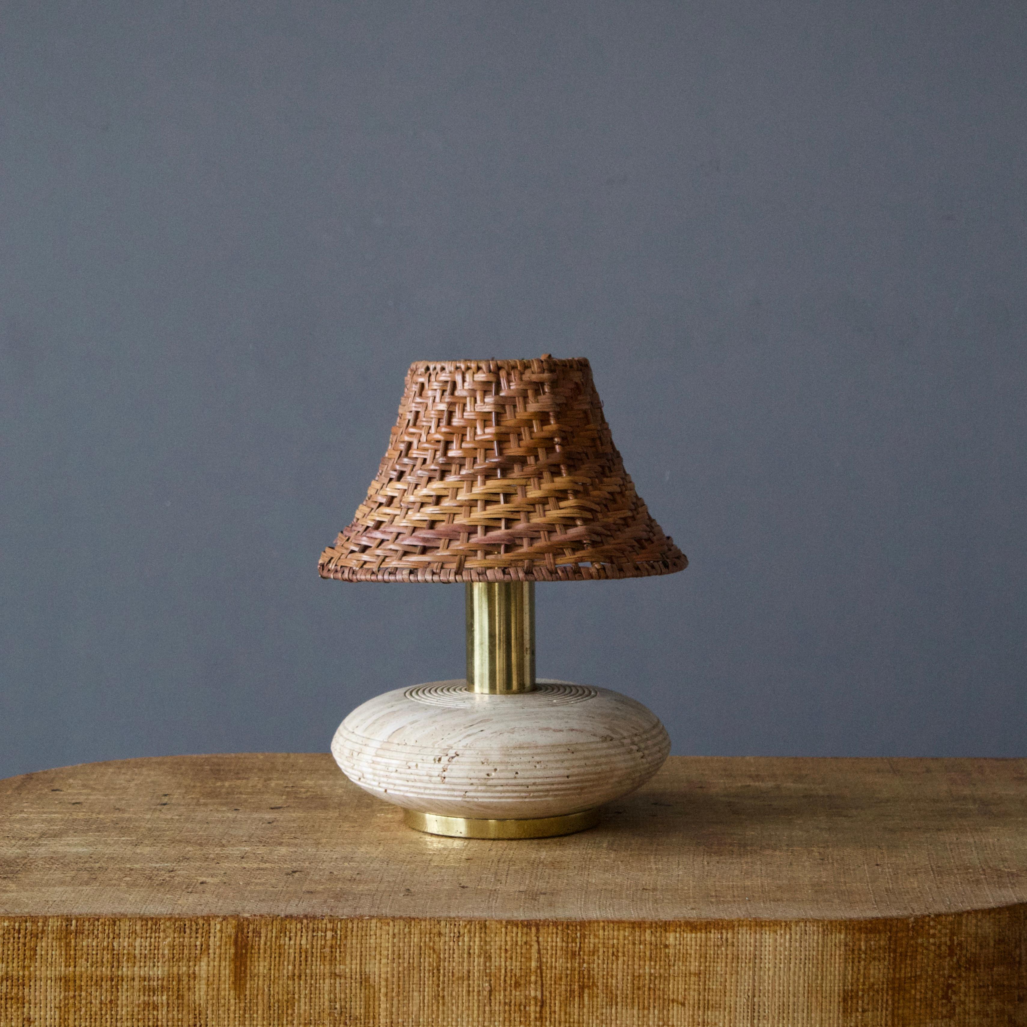 A table lamp, produced in Italy, 1960s. Brass, Travertine, rattan lampshade.

Stated dimensions exclude lampshade, height includes socket.

Other designers of the period include Gio Ponti, Fontana Arte, Max Ingrand, Franco Albini, and Josef