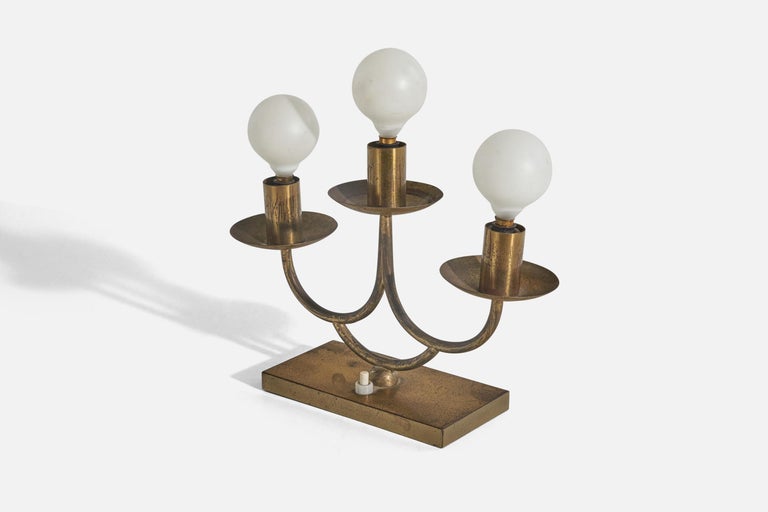 A pair of brass and glass table lamps designed and produced in Italy, 1940s. 

Socket takes Euro base E-12 bulb.

