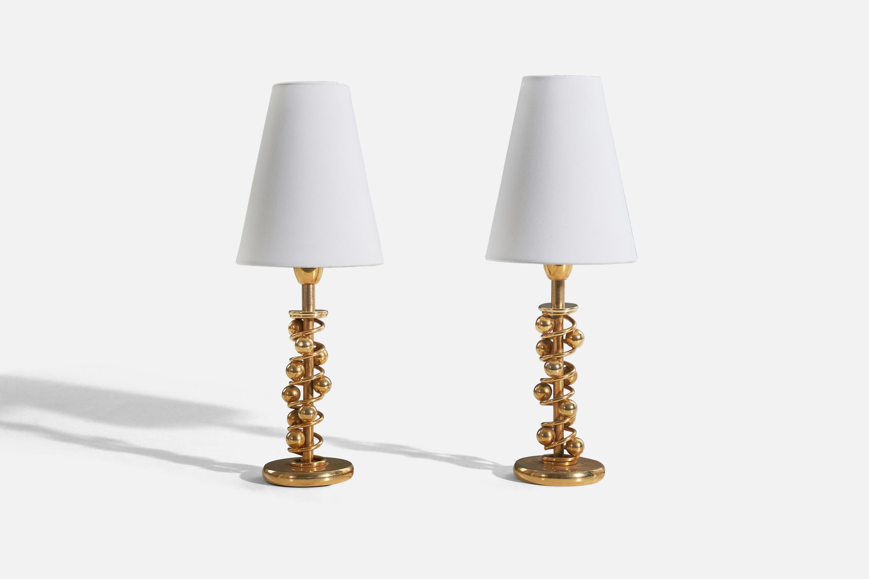 A pair of brass table lamps designed and produced in Italy, c. 1950s.

Sold without lampshade. 
Dimensions of Lamp (inches) : 9.5 x 3.46 x 3.46 (H x W x D)
Dimensions of Shade (inches) : 2.75 x 5.5 x 6.75 (T x B x S)
Dimension of Lamp with