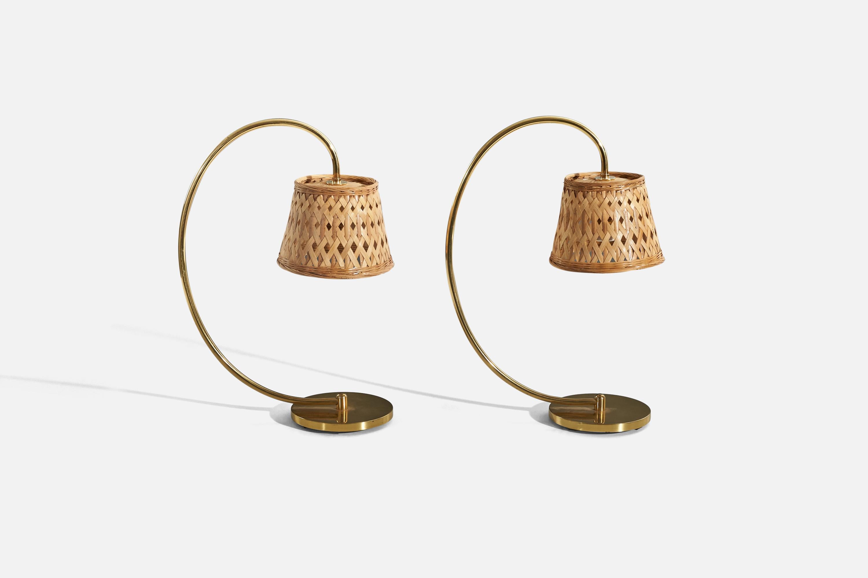 A pair of brass and rattan table lamps designed and produced in Italy, 1950s.

Sold with Lampshade. 
Stated dimensions refer to the Lamp with the Shade.