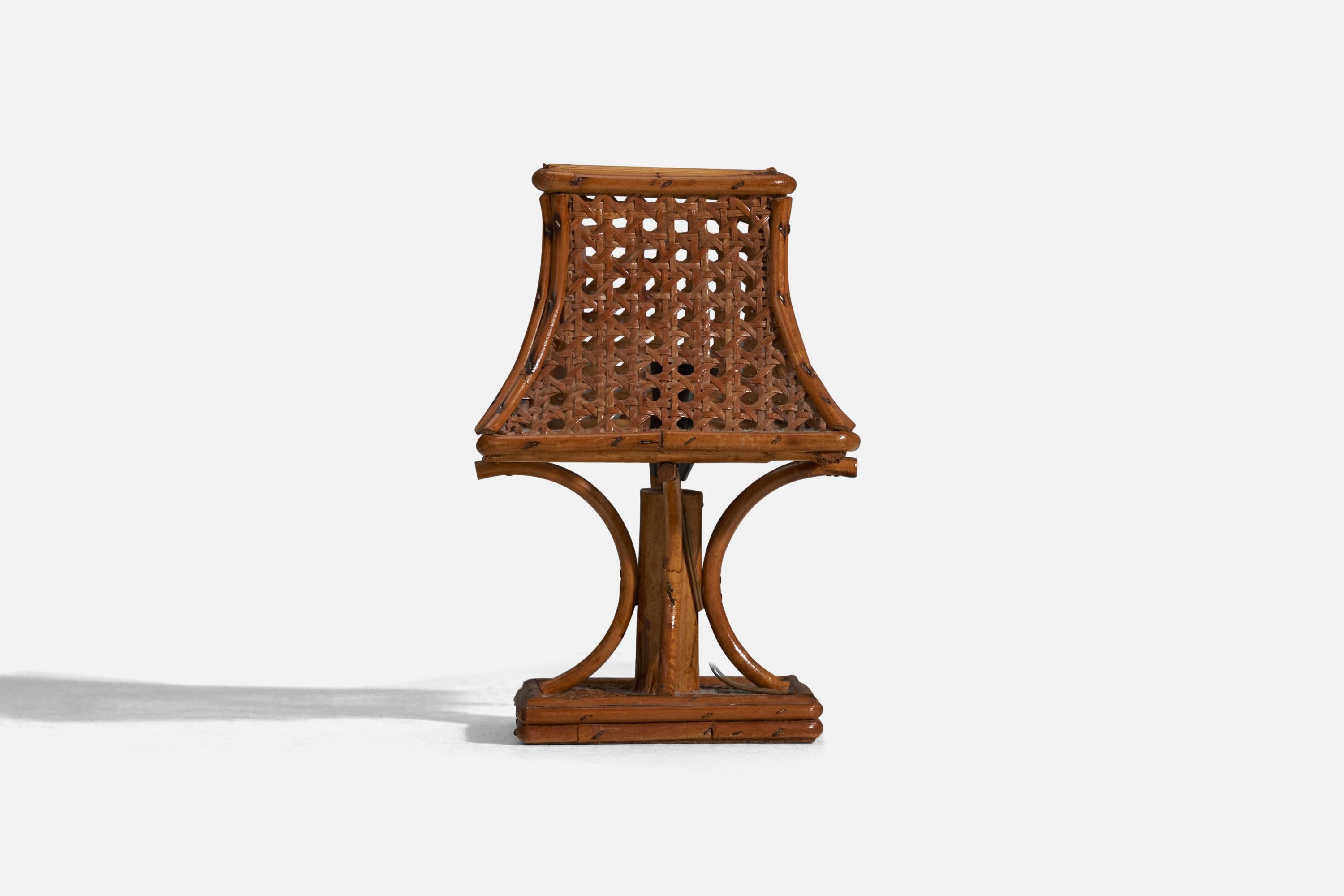 A pair of rattan table lamps designed and produced in Italy, 1970s.

Socket takes E-14 bulb.

There is no maximum wattage stated on the fixture.
