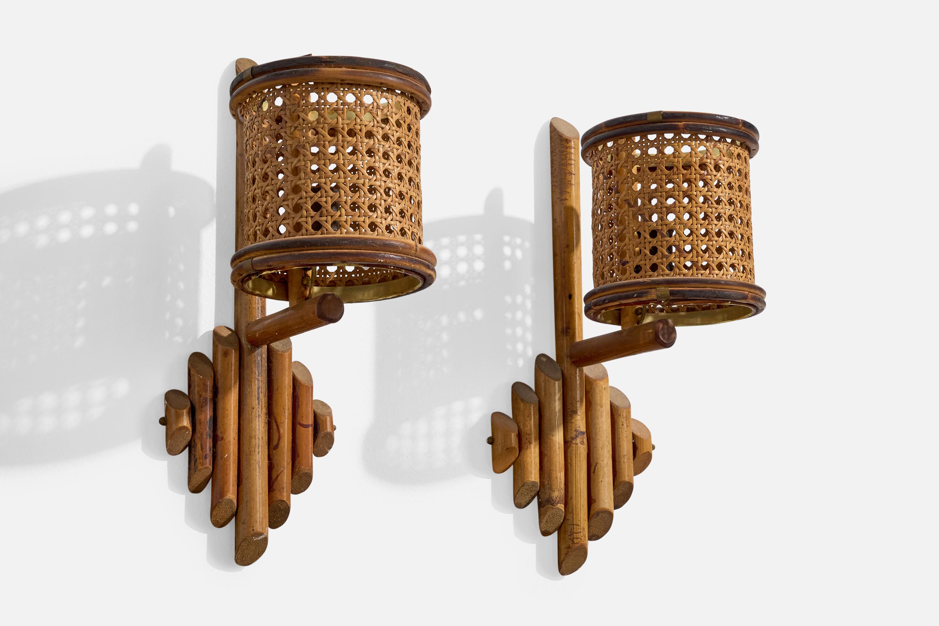 A pair of bamboo and cane wall lights designed and produced in Italy, c. 1960s.

Overall Dimensions (Inches): 15.25” H x 5.5” W x 8.25” D 

Bulb Specifications: E-14

Number of Sockets (per fixture): 2

Does not include mounting hardware.

Sold with