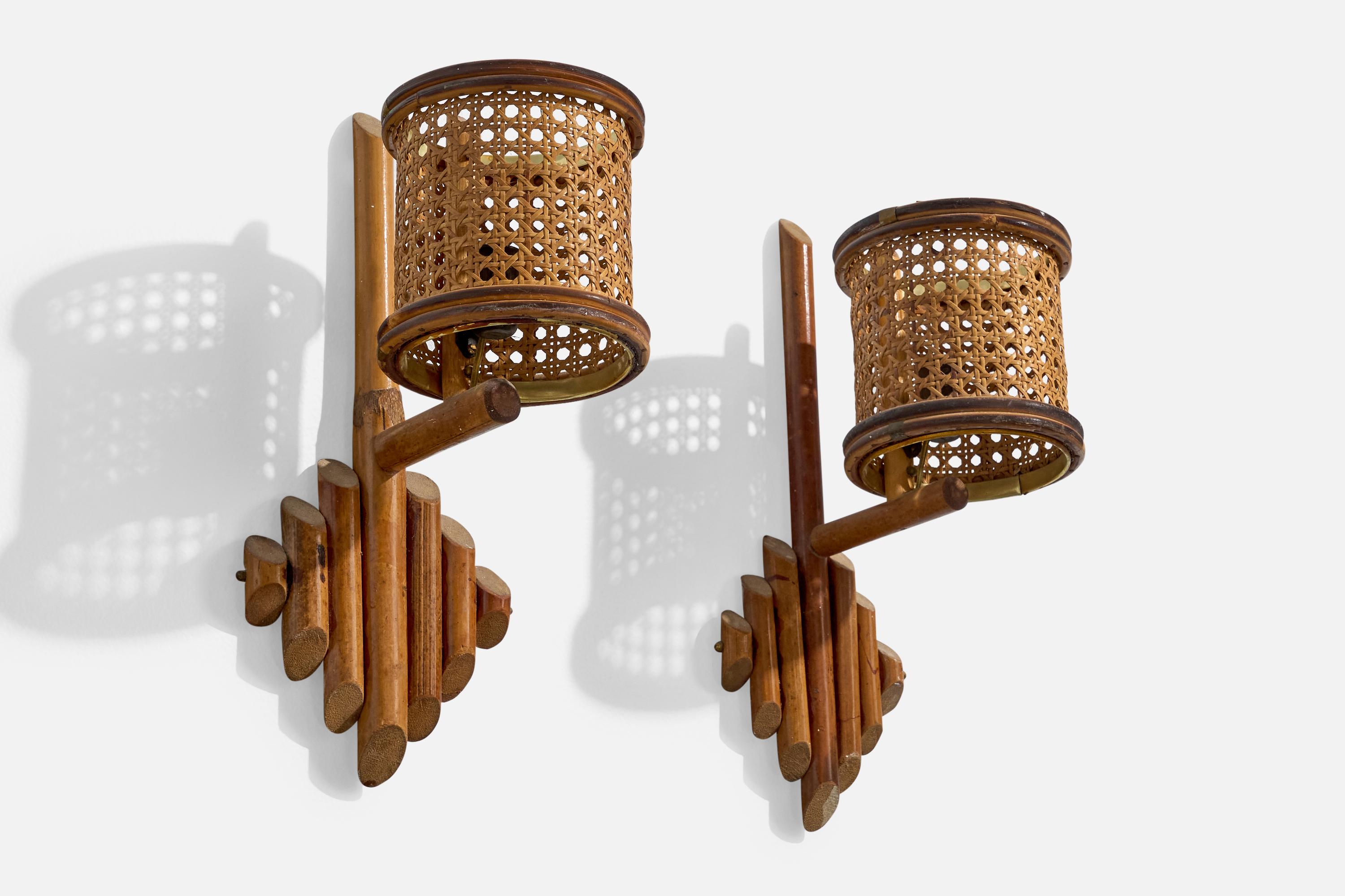 A pair of bamboo and cane wall lights designed and produced in Italy, c. 1960s.

Overall Dimensions (Inches): 15.25” H x 5.5” W x 8.25” D 

Bulb Specifications: E-14

Number of Sockets (per fixture): 2

Does not include mounting hardware.

Sold with