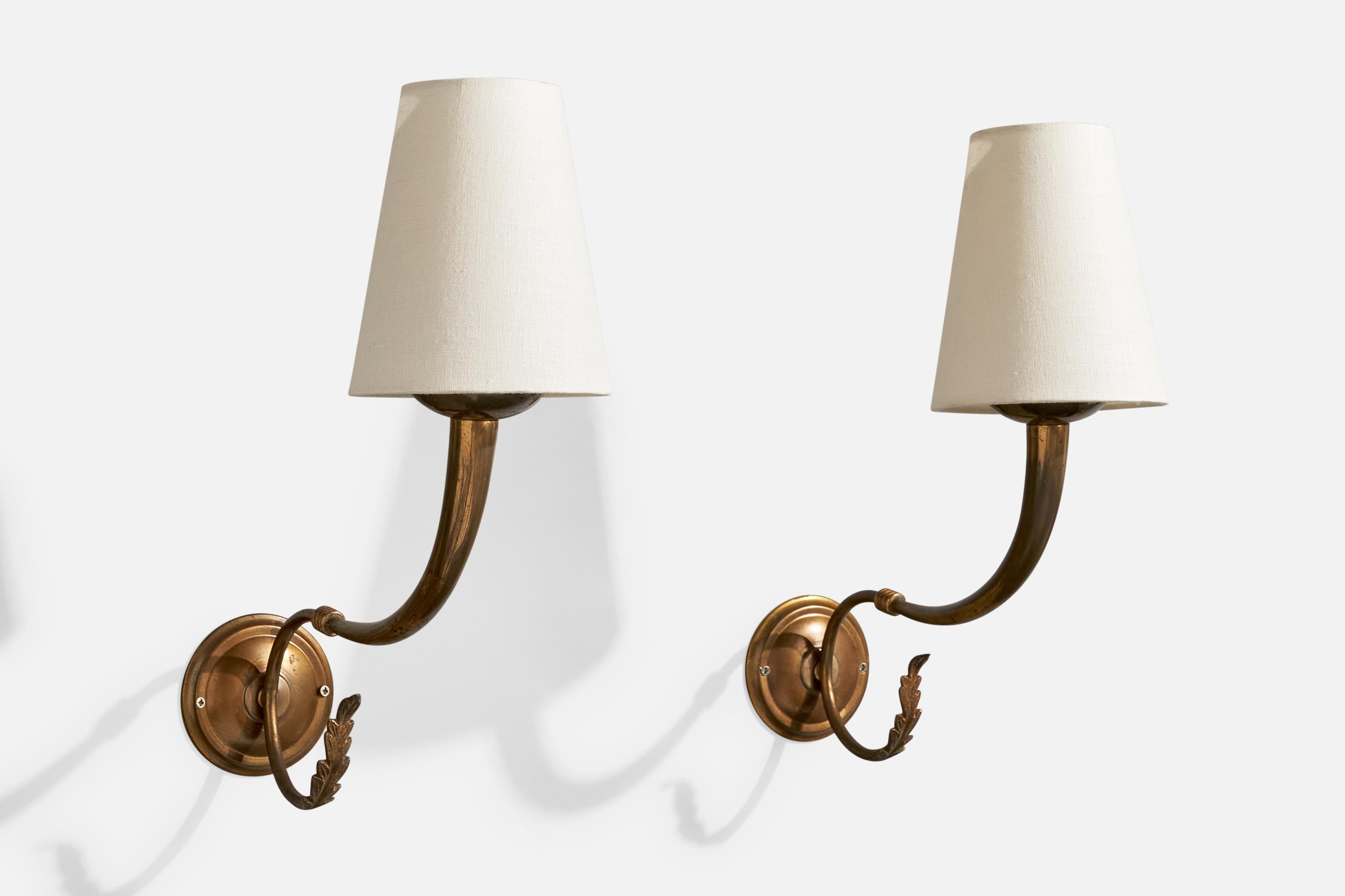 A pair of brass and white fabric wall lights designed and produced in Italy, c. 1940s.

Overall Dimensions (Inches): 15” H x 5.125” W x 11.5“ D

Back Plate Dimensions (Inches): 3.625” H x 3.625“ W x .8” D

Bulb Specifications: E-14 candle

Number of
