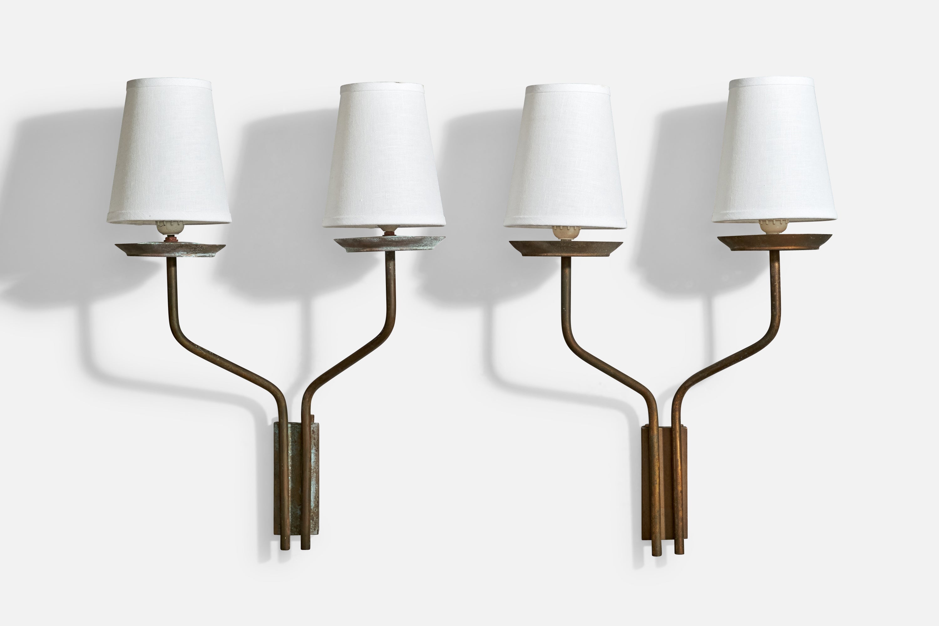 A pair of brass and white fabric wall lights designed and produced in Italy, c.1950s.

Overall Dimensions (inches): 24” H x 17.375” W x 8.25“ D

Back Plate Dimensions (Inches): 5.875” H x 2.375” W x .75” D

Bulb Specifications: E-26 candle

Number