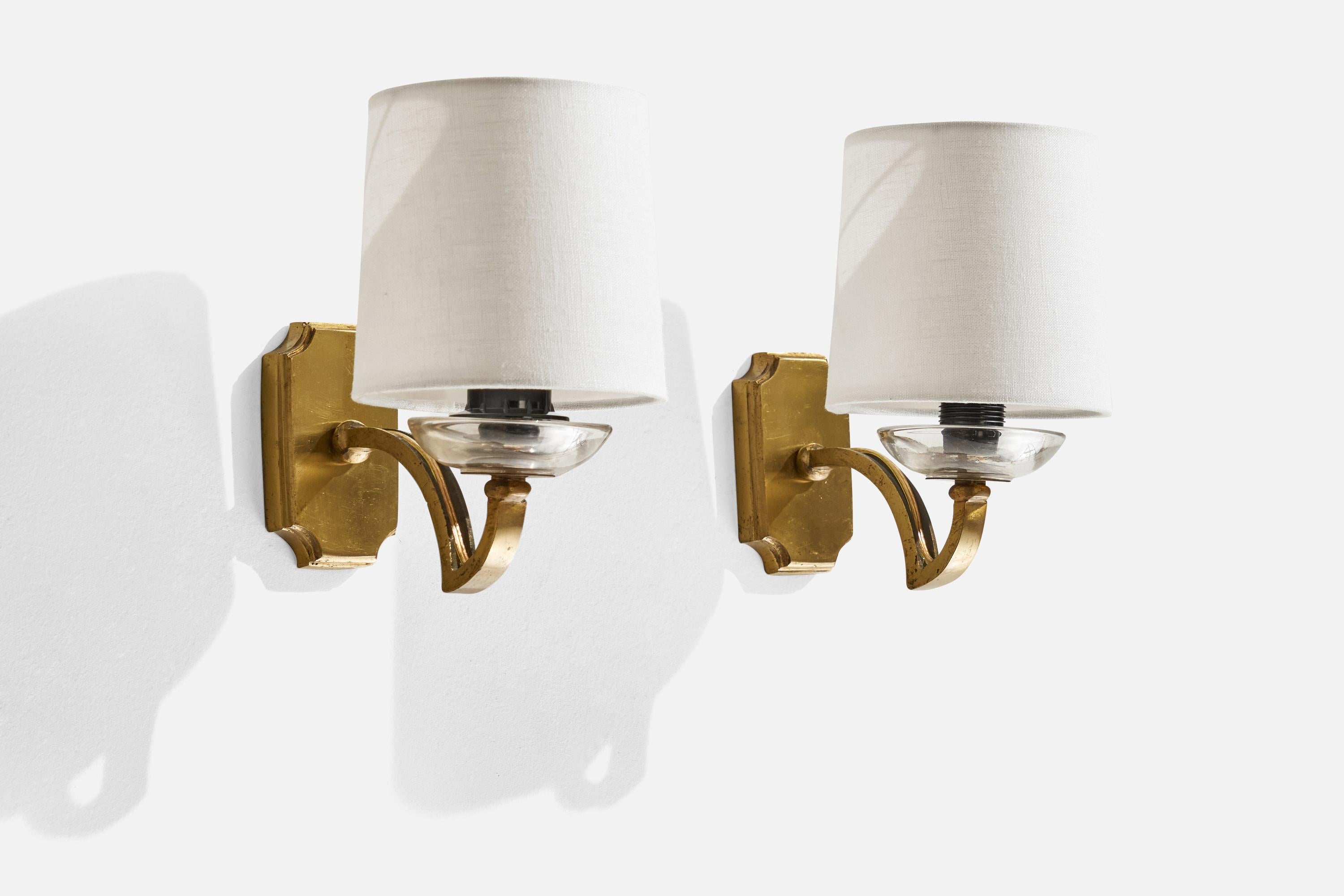 A pair of brass, glass and white fabric wall lights designed and produced in Italy, 1950s.

Overall Dimensions (inches): 7.259” H x 4.55” W x 6” D
Back Plate Dimensions (inches): 3.81” H x 2.28” W x 0.62” D
Bulb Specifications: E-12 Bulb
Number of