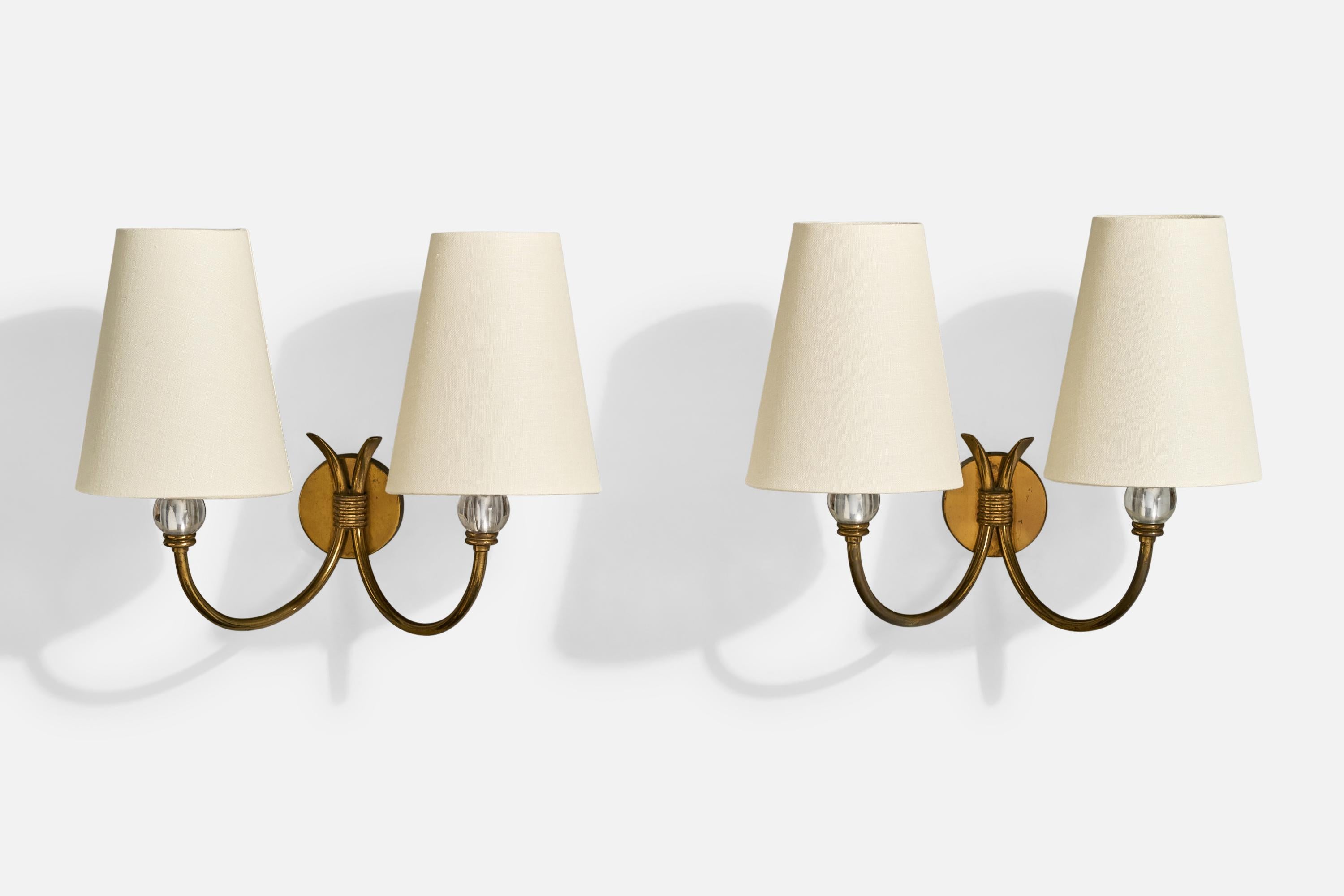 A pair of brass, glass and white fabric wall lights designed and produced in Italy, c. 1950s.

Overall Dimensions (Inches): 10.5” H x 11.2” W x 7“ D

Back Plate Dimensions (Inches): 2.5” H x 2.5“ W x .65” D

Bulb Specifications: E-14 incandescent