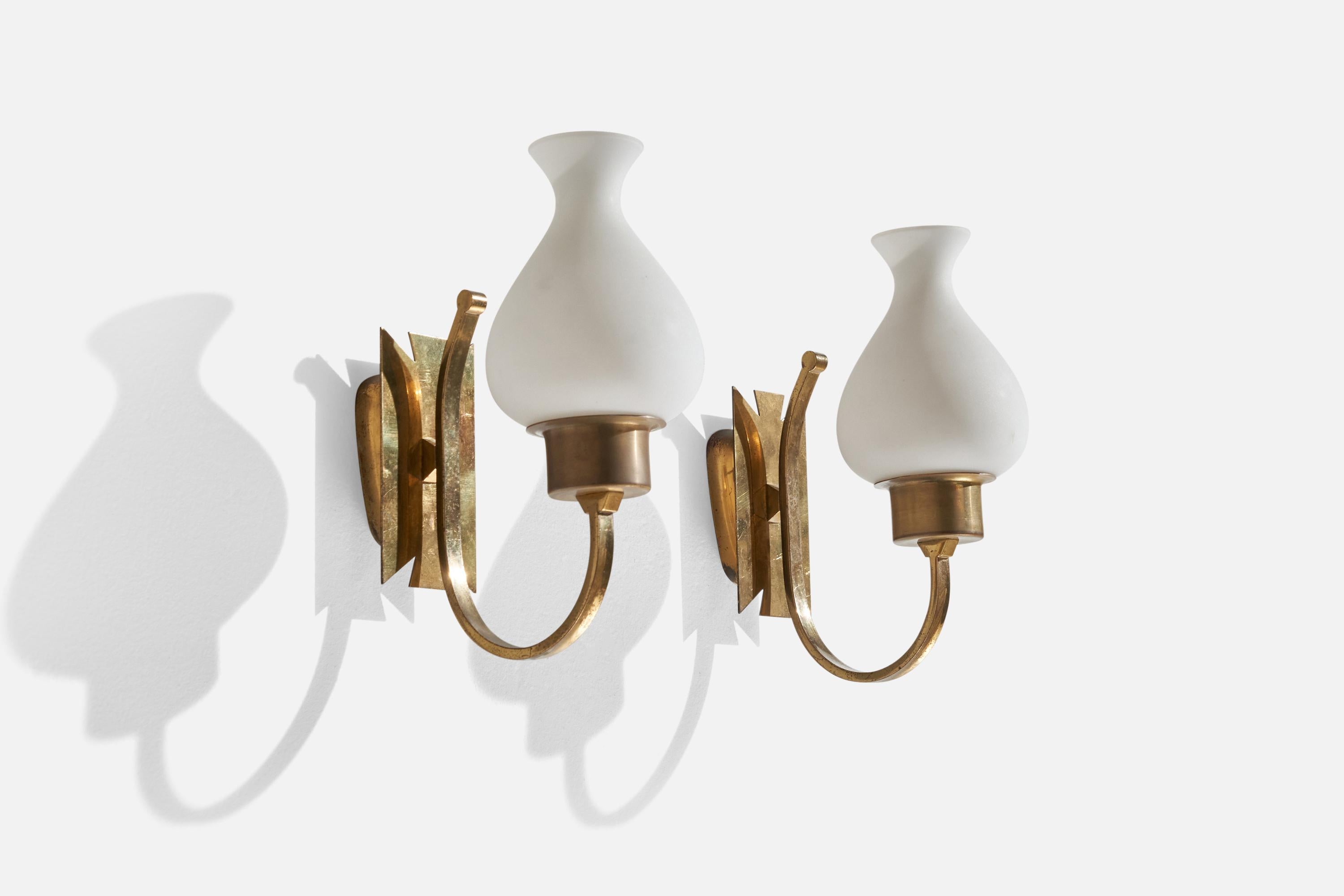 A pair of brass and opaline glass wall lights designed and procuced in Italy, 1940s.

Overall Dimensions (inches): 9.75” H x 4.25” W x 7.25” D
Back Plate Dimensions (inches): 3.5” H x 2.5” W x 0.75”
Bulb Specifications: E-14 Bulbs
Number of Sockets:
