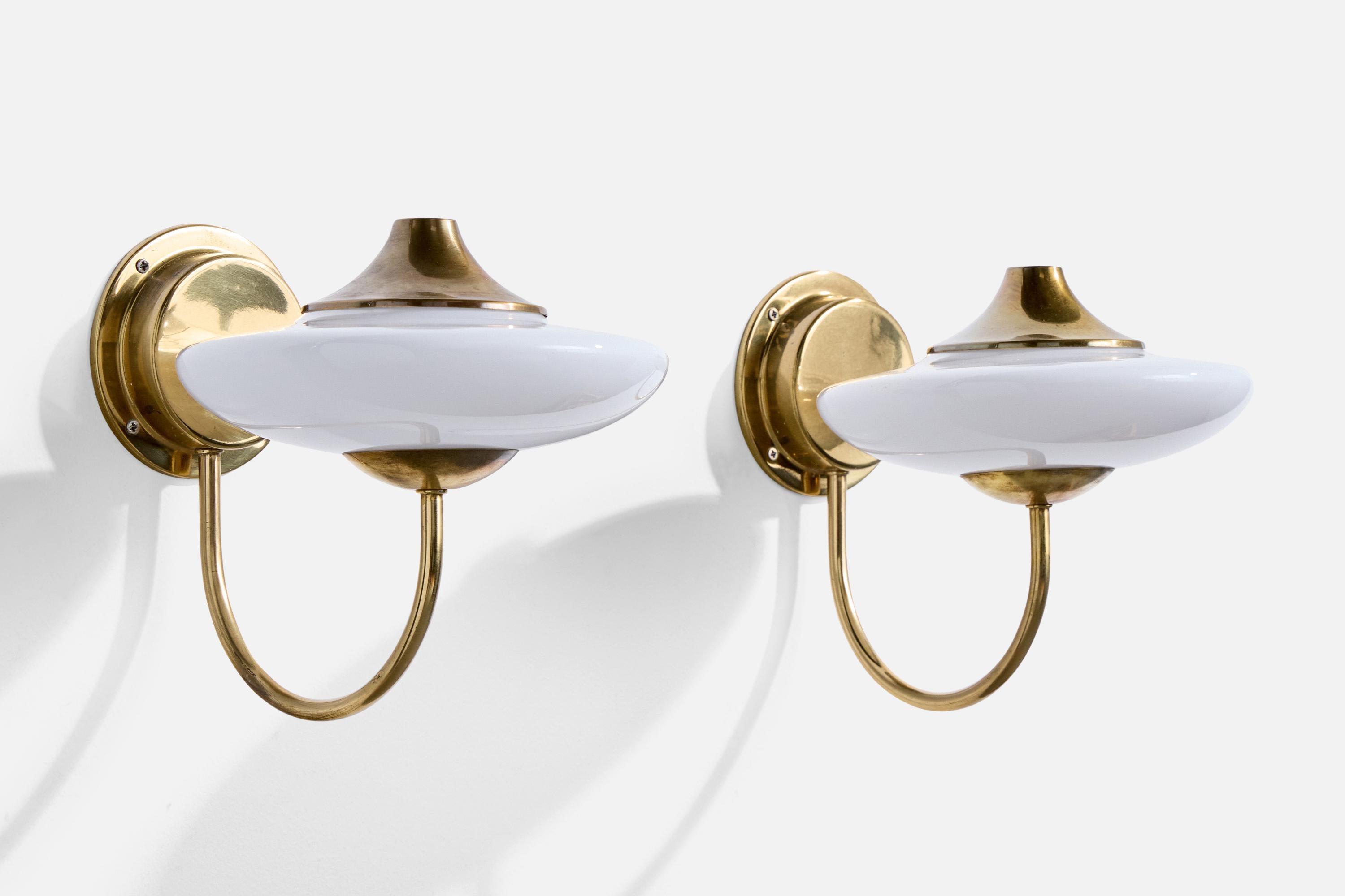 A pair of brass and white opaline glass wall lights designed and produced in Italy, c. 1960s.

Overall Dimensions (Inches): 8.4” H x 8” W x 9.75“ D

Back Plate Dimensions (Inches): 4.25” H x 4.25“ W x 1.125” D

Bulb Specifications: E-14