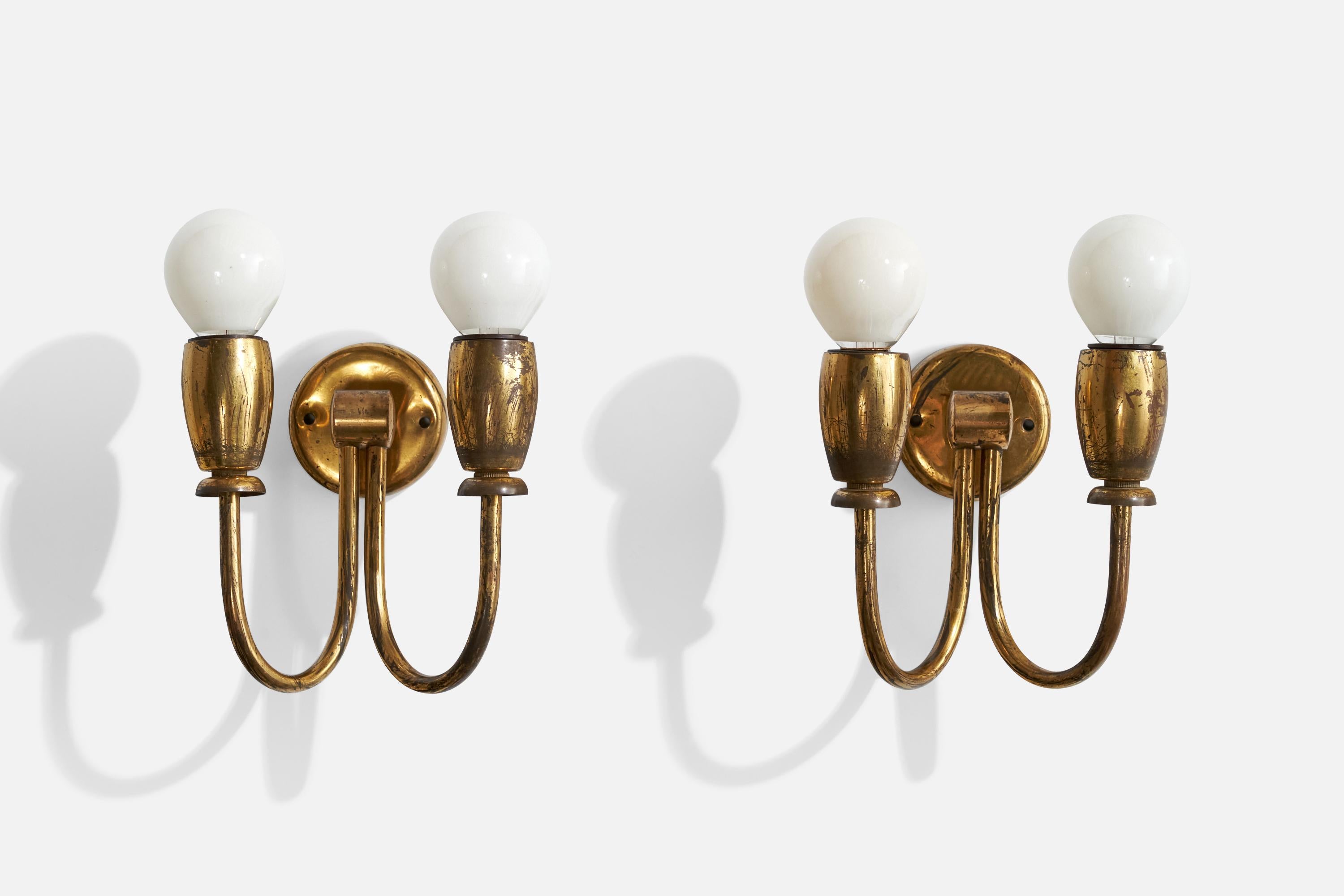 A pair of brass wall lights designed and produced in Italy, c. 1930s.

Overall Dimensions (inches):  7” H x  6” W x  4.675” D

Back Plate Dimensions (Inches):  2.375” H x 2.375” W x .5” D

Bulb Specifications: E-14

Number of Sockets (per fixture):