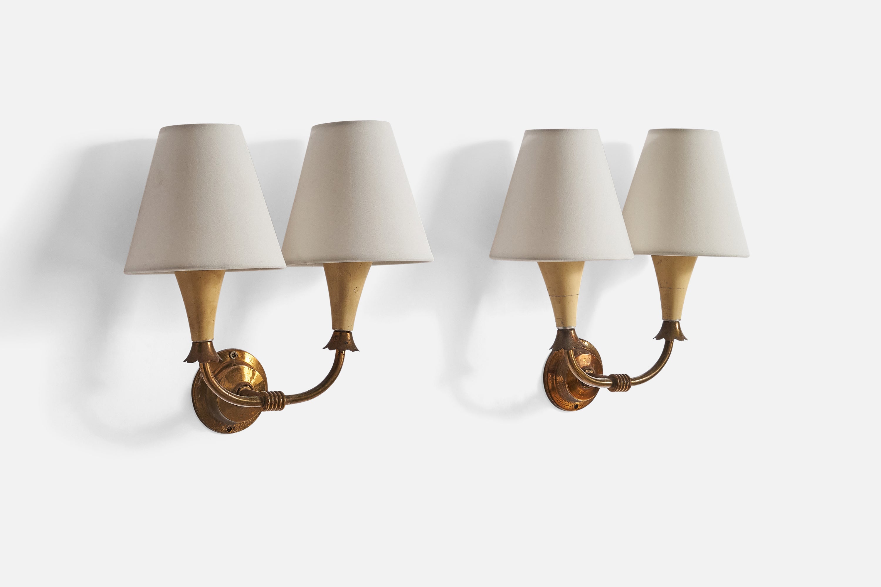 A pair of brass, beige-lacquered metal and white fabric wall lights designed and produced in Italy, 1940s.

Overall Dimensions (inches): 6.75”  H x 7.5” W x 3.25” D
Back Plate Dimensions (inches): 2.5” H x 2.5”  W x .75”  D
Bulb Specifications: E-14
