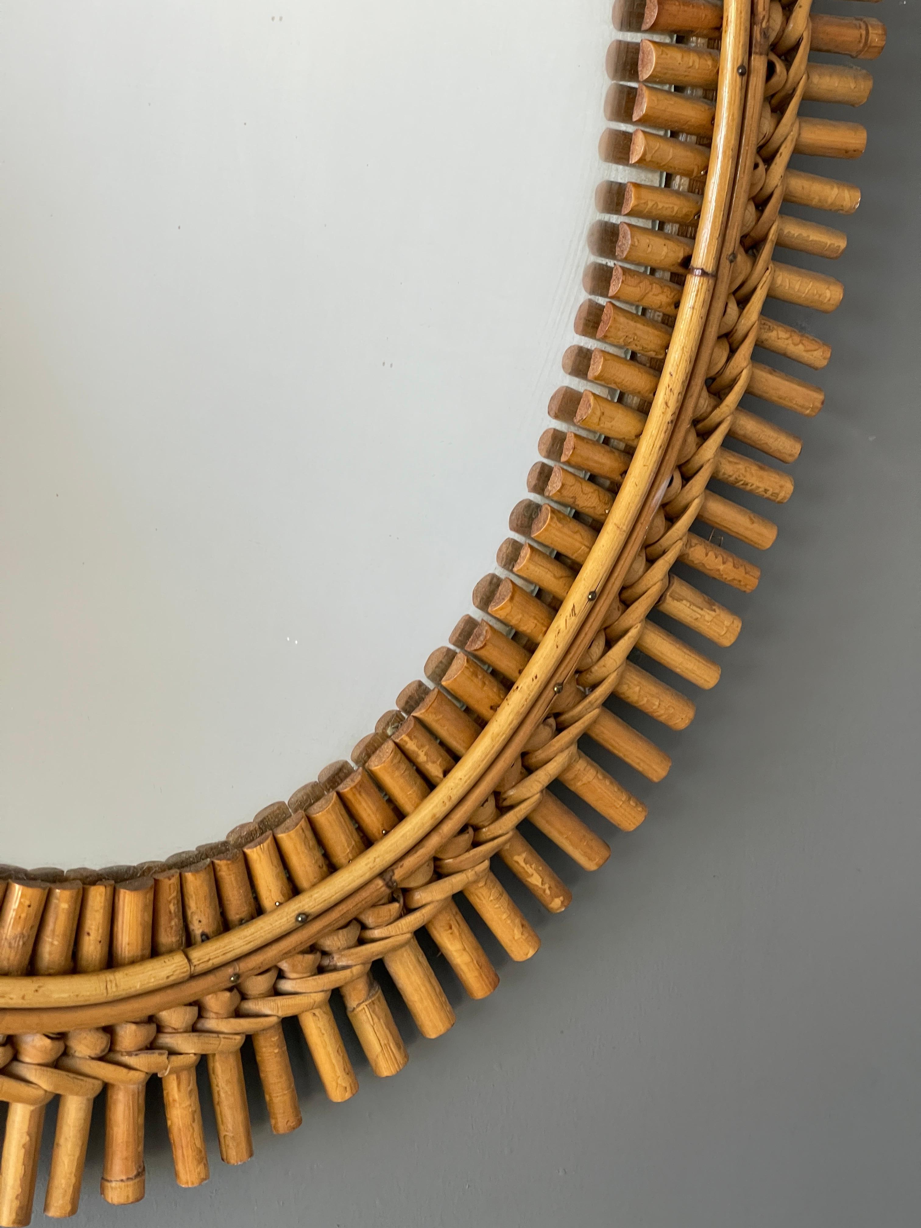 A wall mirror, produced in Italy, 1950s. Cut mirror glass is framed in bamboo and rattan

Other designers of the period include Gio Ponti, Fontana Arte, Max Ingrand, Franco Albini, and Josef Frank.