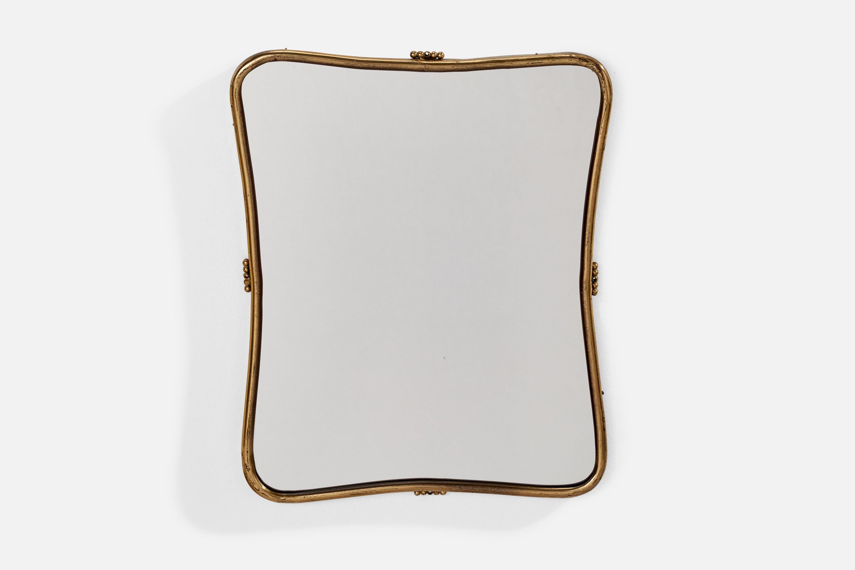 A brass wall mirror designed and produced in Italy, 1940s.