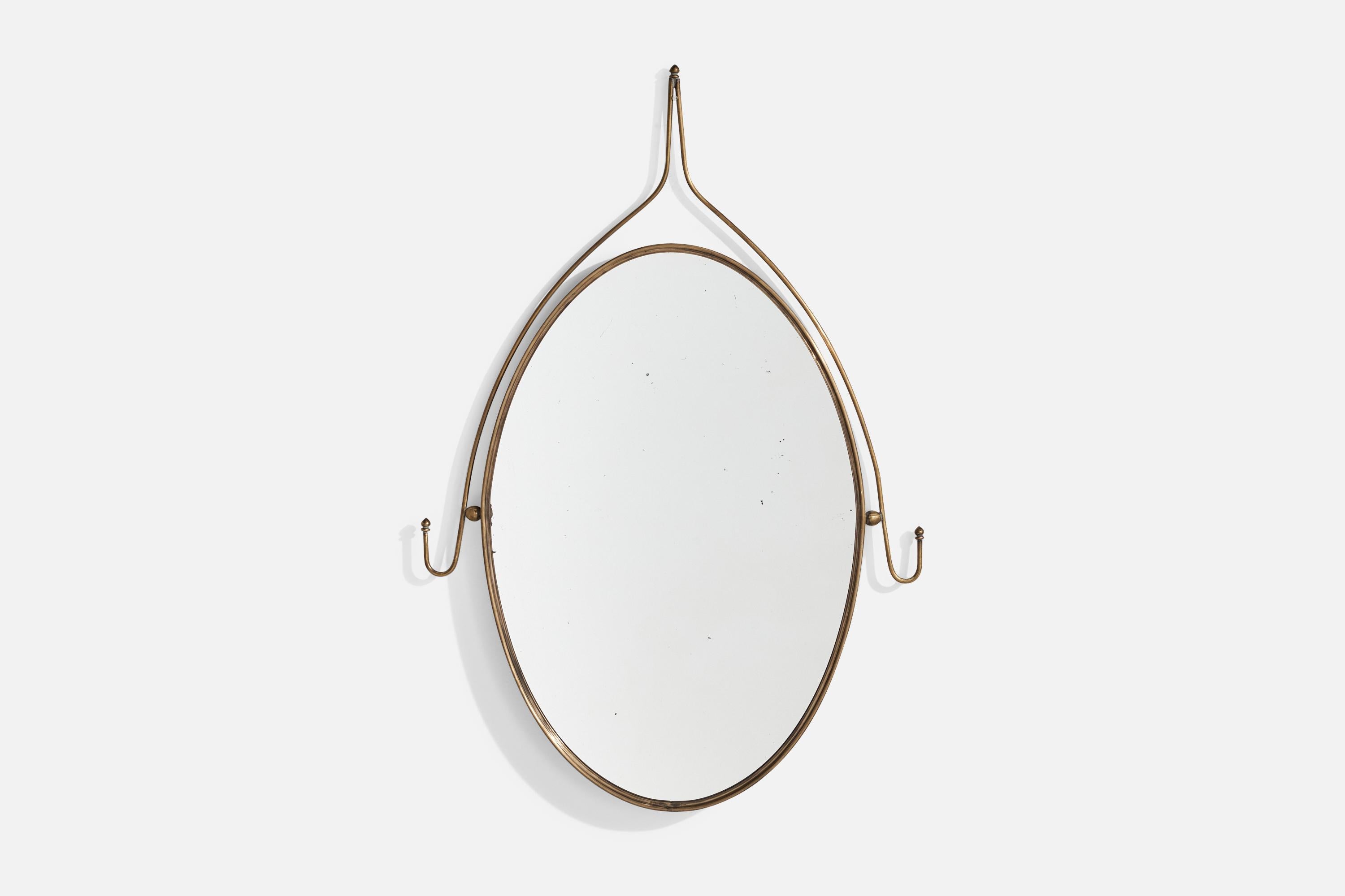 A brass wall mirror designed and produced in Italy, c. 1940s.

Dimensions: 31.5” H x 21.5” W x 1” D