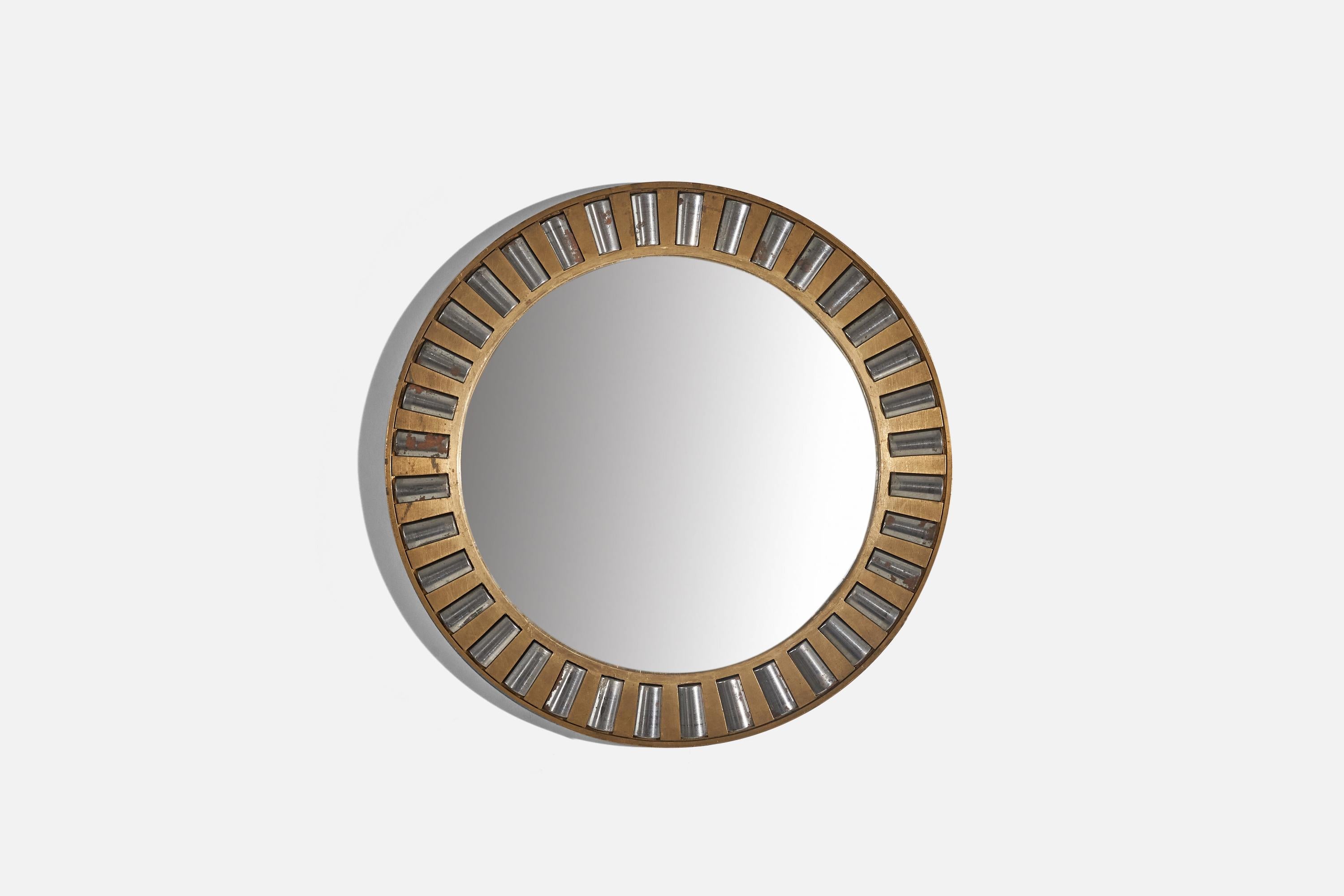 A heavy-alloy brass and metal wall mirror designed and produced in Italy, c. 1940s.
 