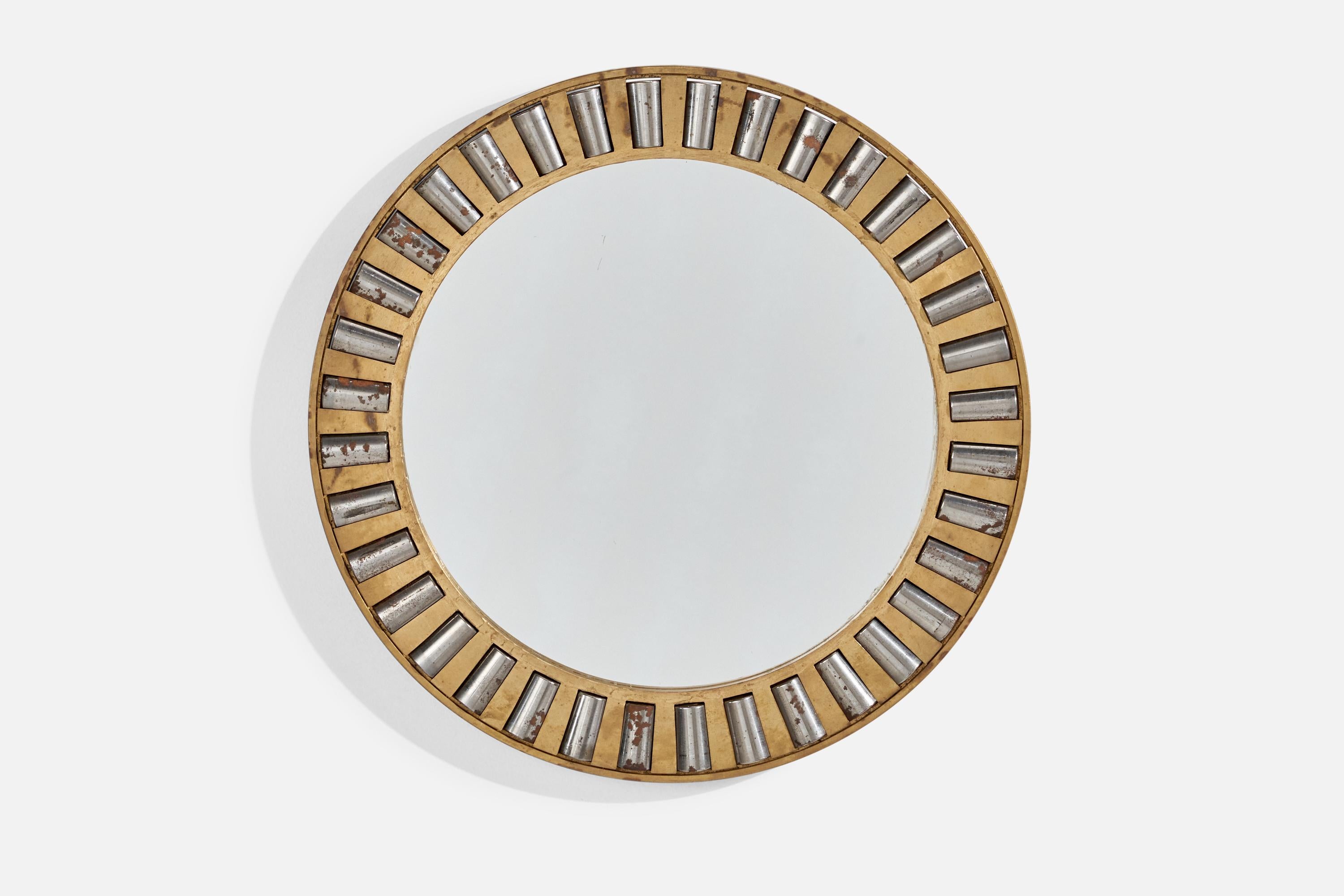 A heavy-alloy brass and metal wall mirror designed and produced in Italy, c. 1940s.
 