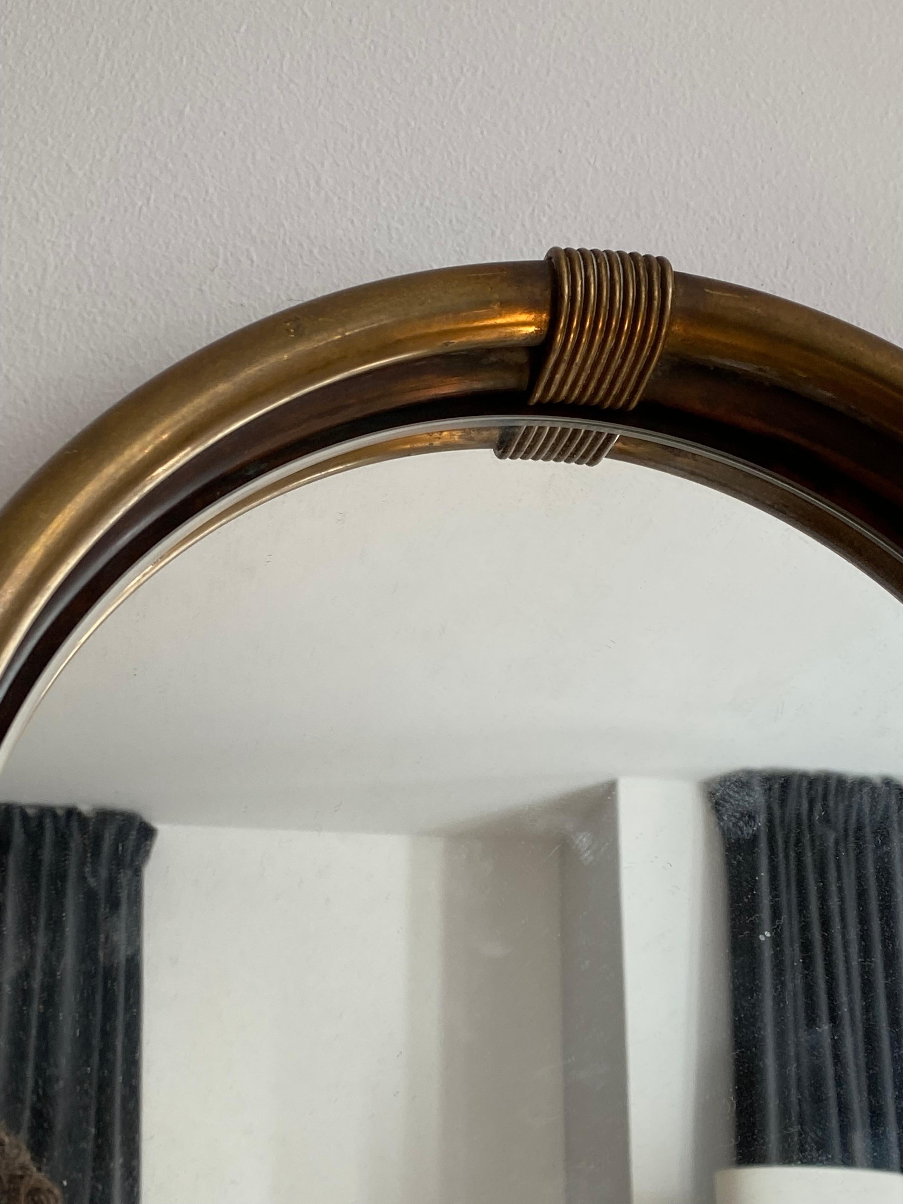 A wall mirror, produced in Italy, 1940s-1950s. Cut mirror glass is framed in brass frame.

Other designers of the period include Gio Ponti, Fontana Arte, Paolo Buffa, Franco Albini, and Jean Royere.