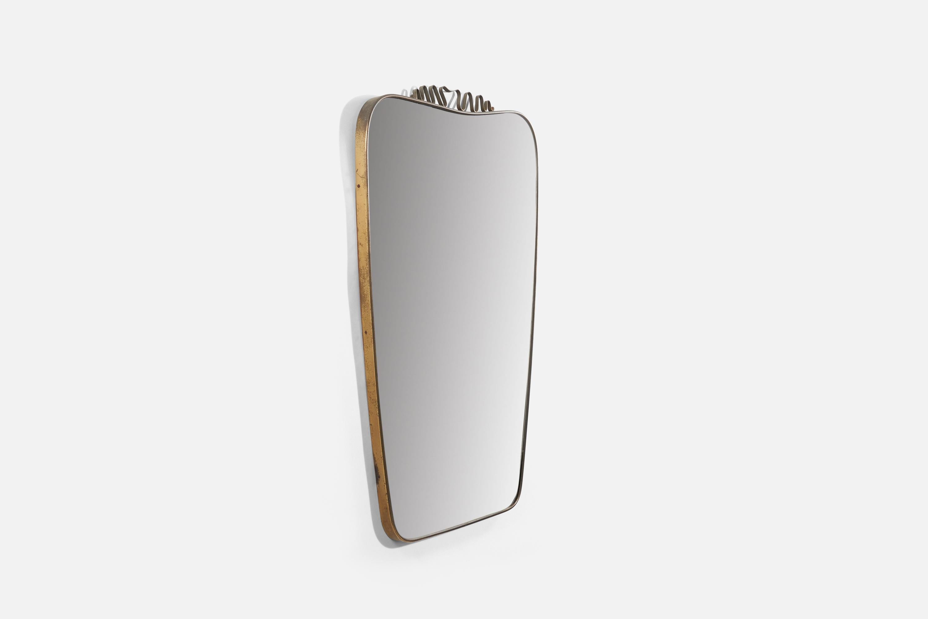 A brass wall mirror produced in Italy, 1940s. 
 