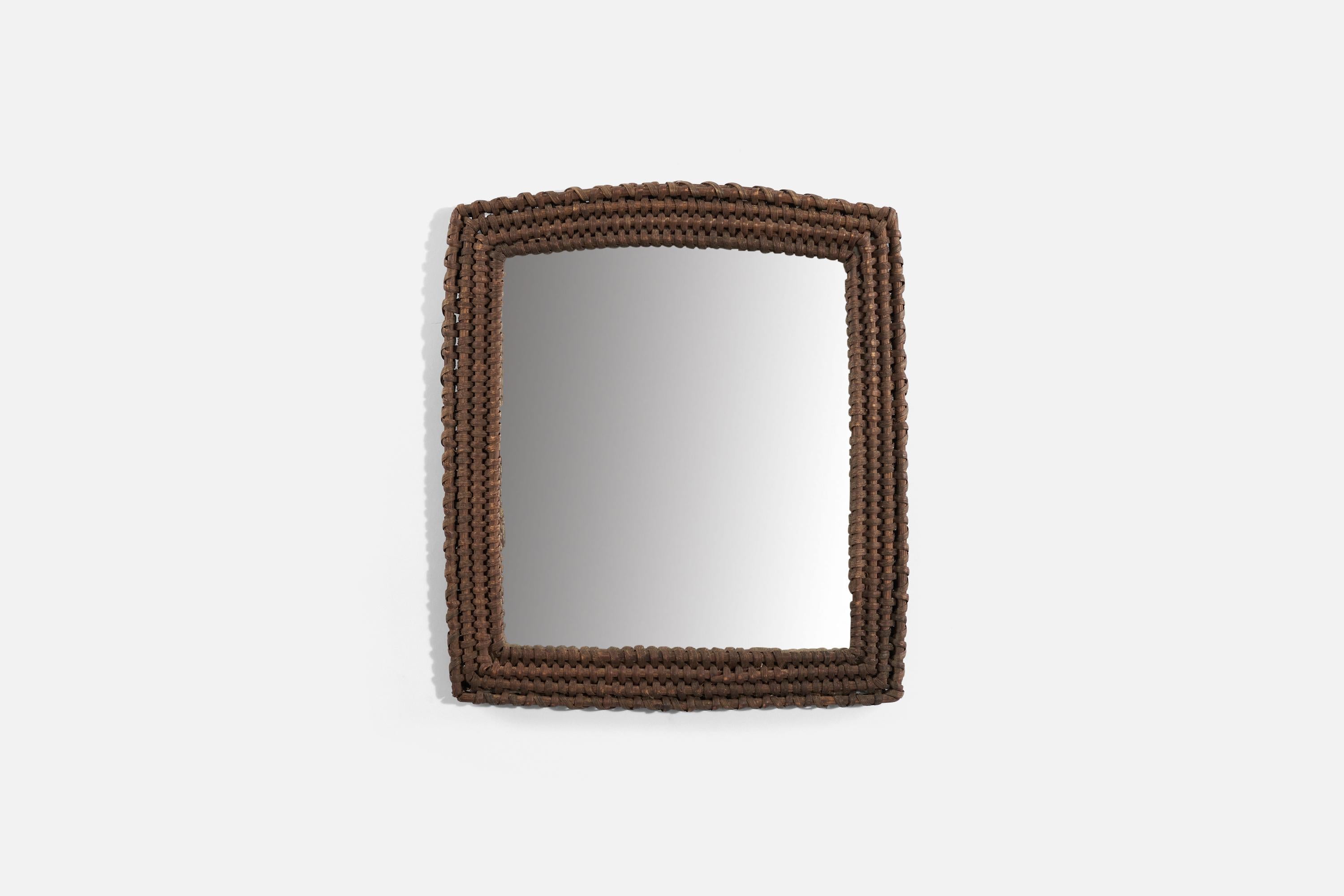 A dark-stained rattan wall mirror produced in Italy, c. 1950s.
 