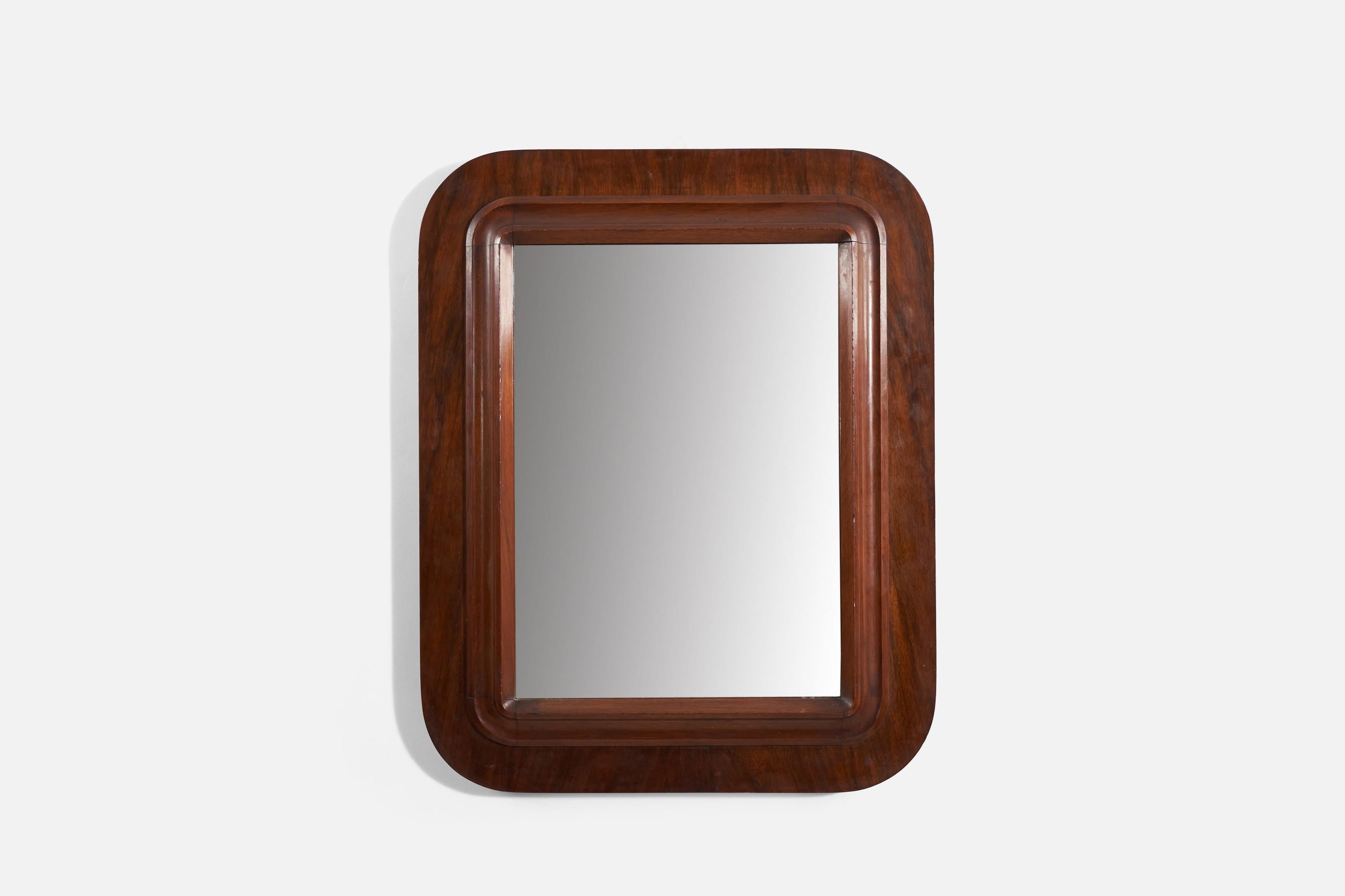 A dark-stained wooden wall mirror produced in Italy, 1940s. 
 