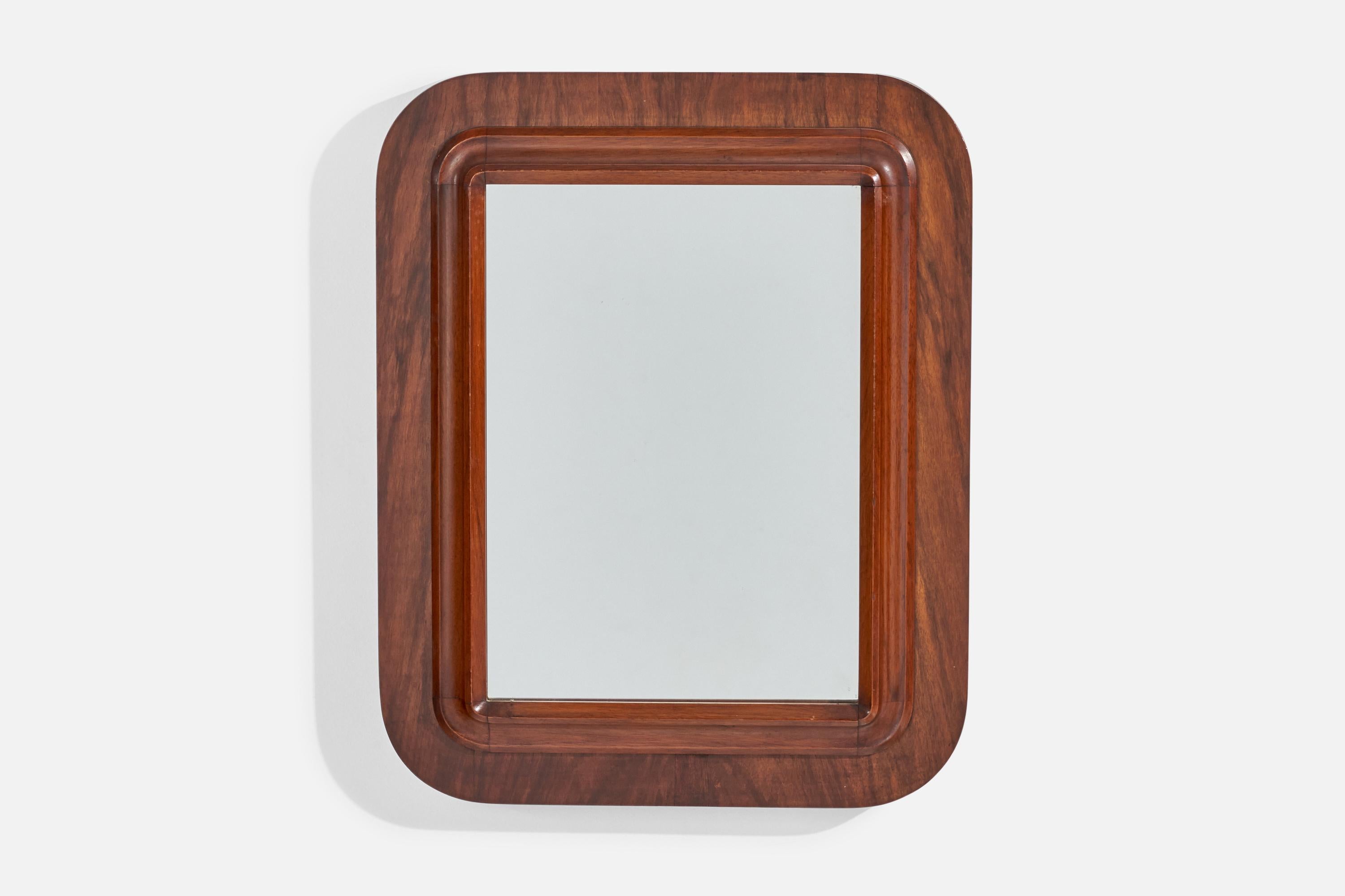 Espejo de pared de madera oscura fabricado en Italia, años 40. 
 