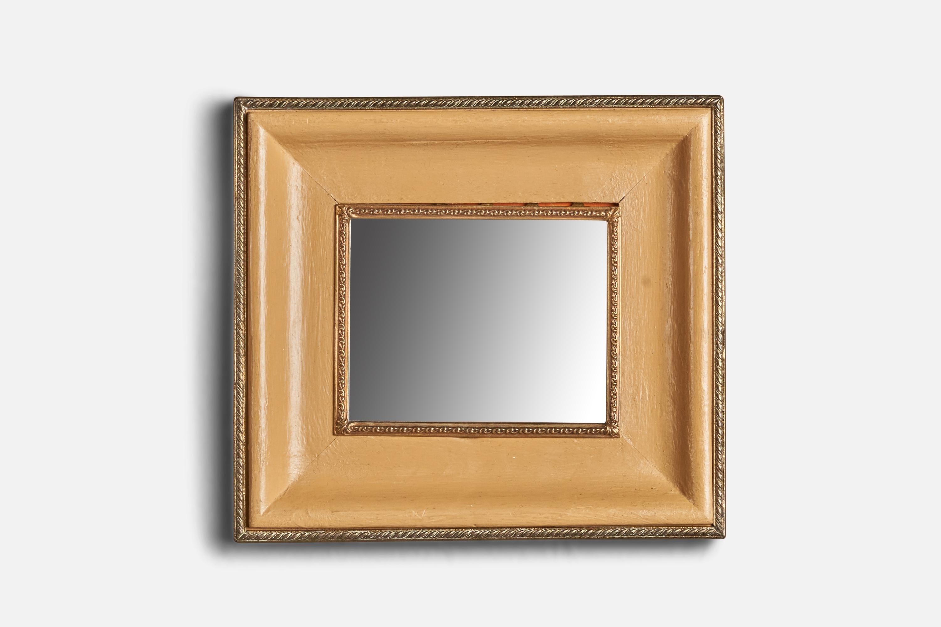 A brass and beige parchment paper wall mirror designed and produced in Italy, 1940s.