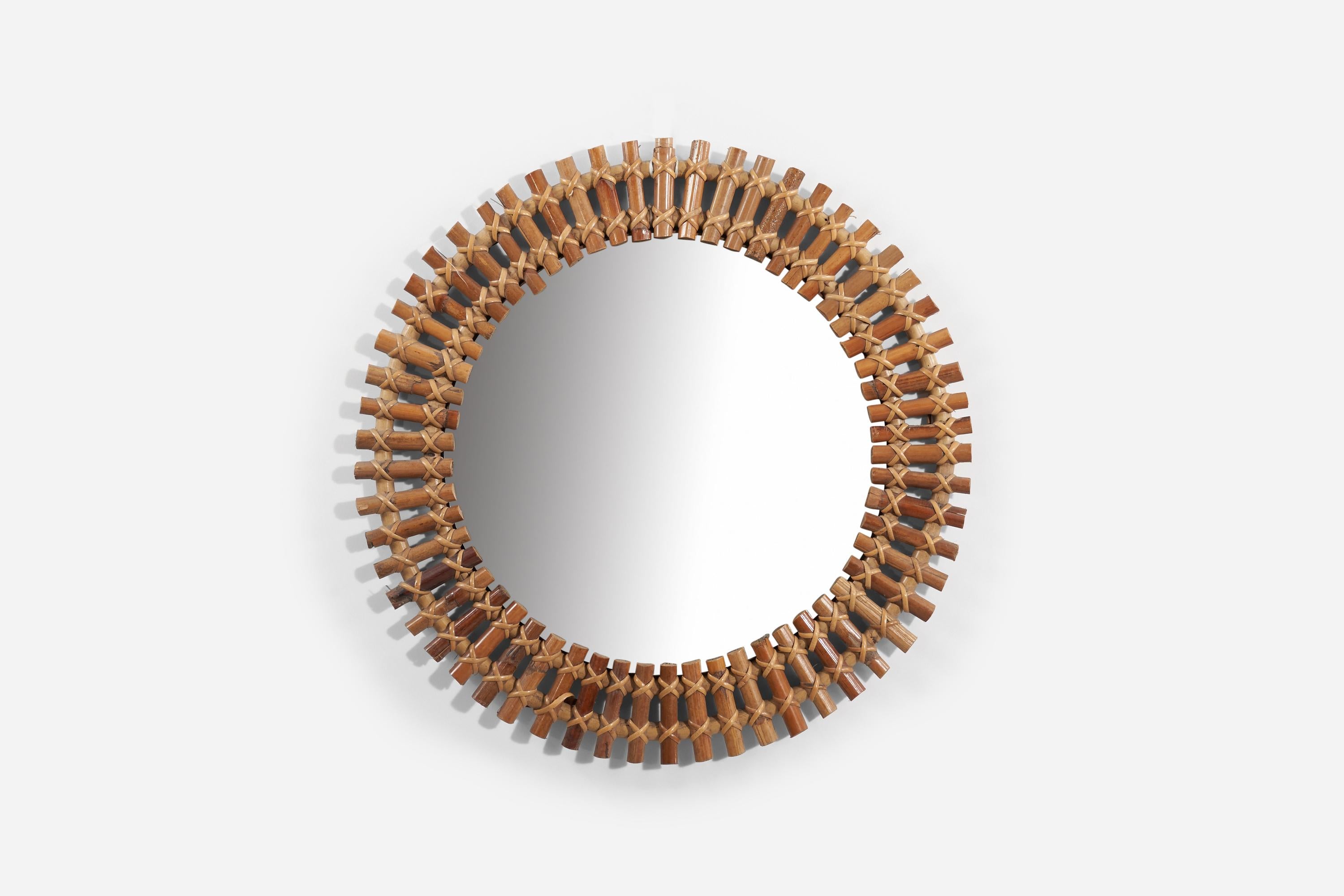 A bamboo and rattan wall mirror produced in Italy, 1950s. 
 