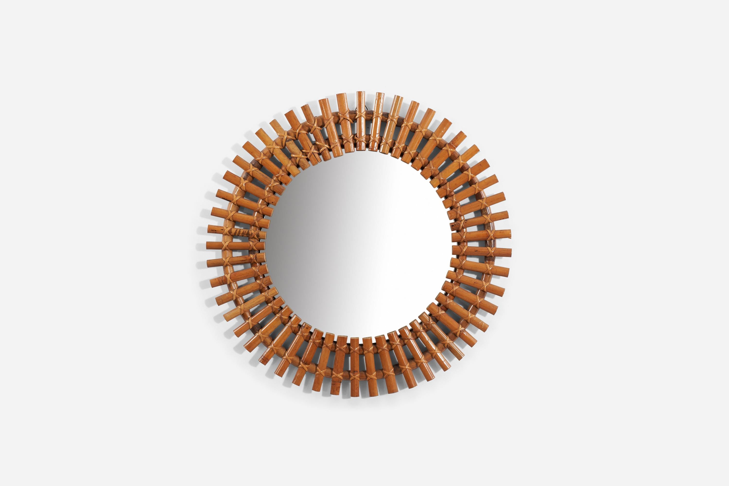 A bamboo and rattan wall mirror produced in Italy, 1950s. 
 