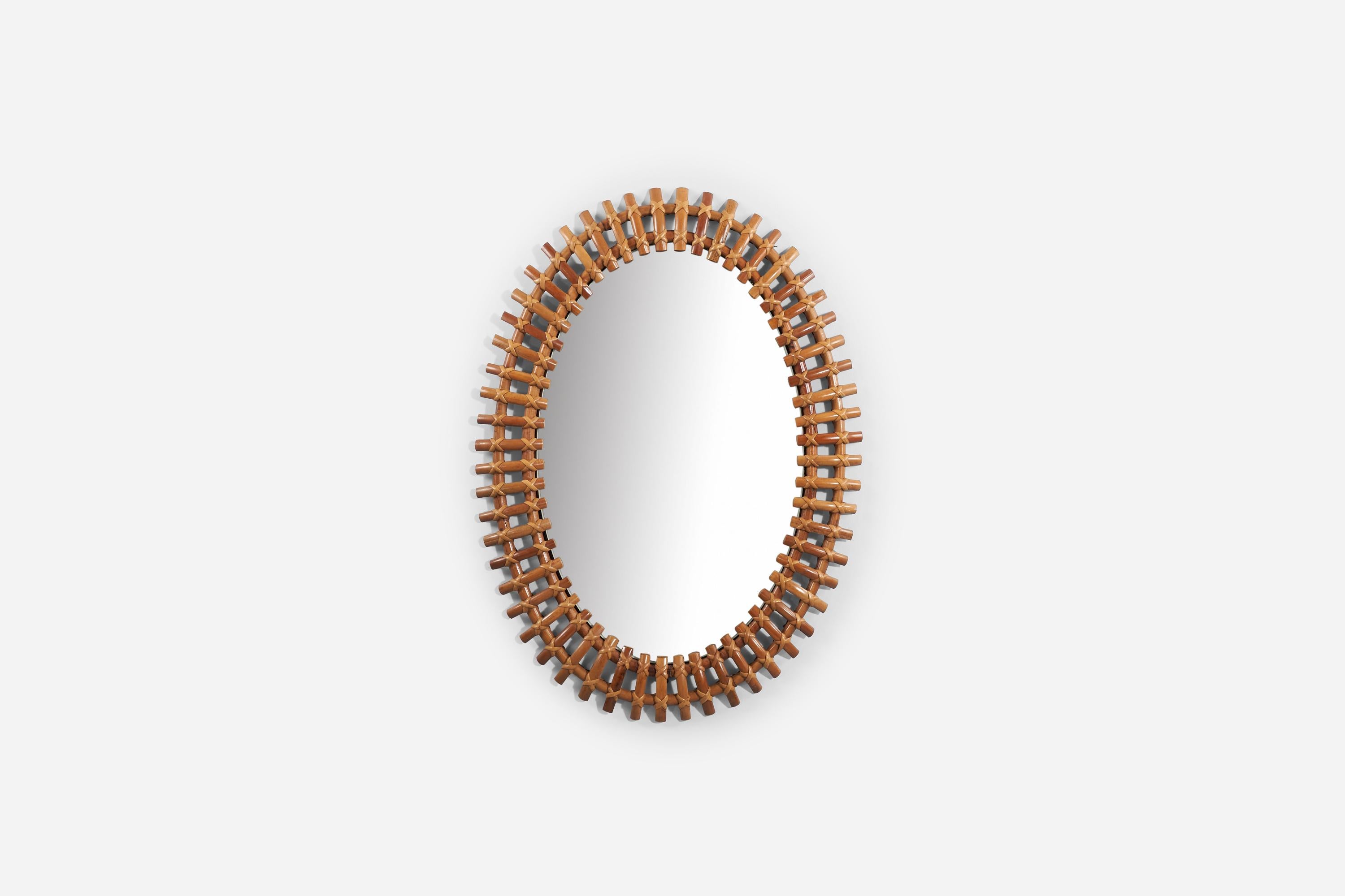 A bamboo and rattan wall mirror produced in Italy, 1950s. 
 