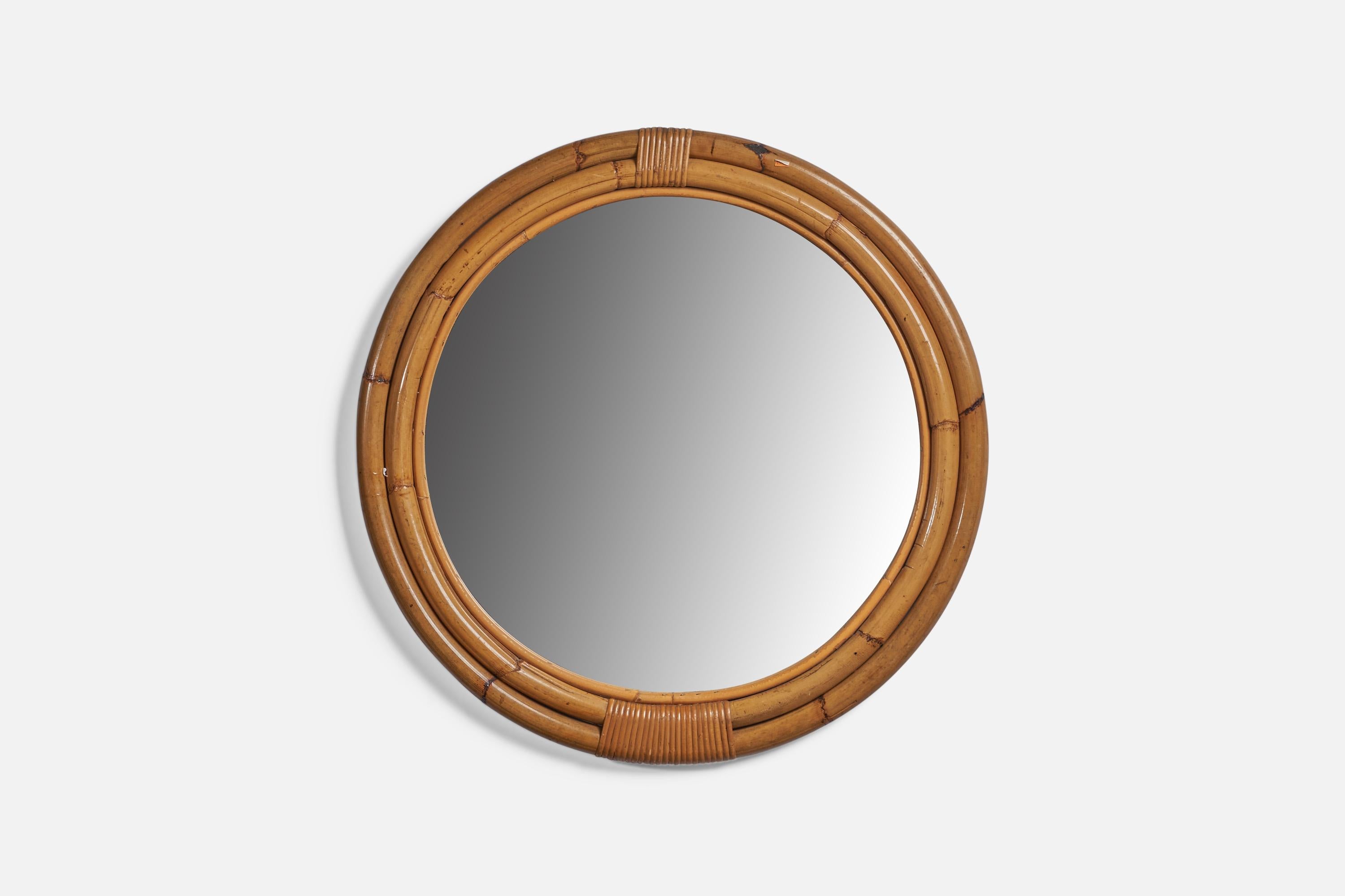 A round bamboo and rattan wall mirror, designed and produced in Italy, c. 1950s.
