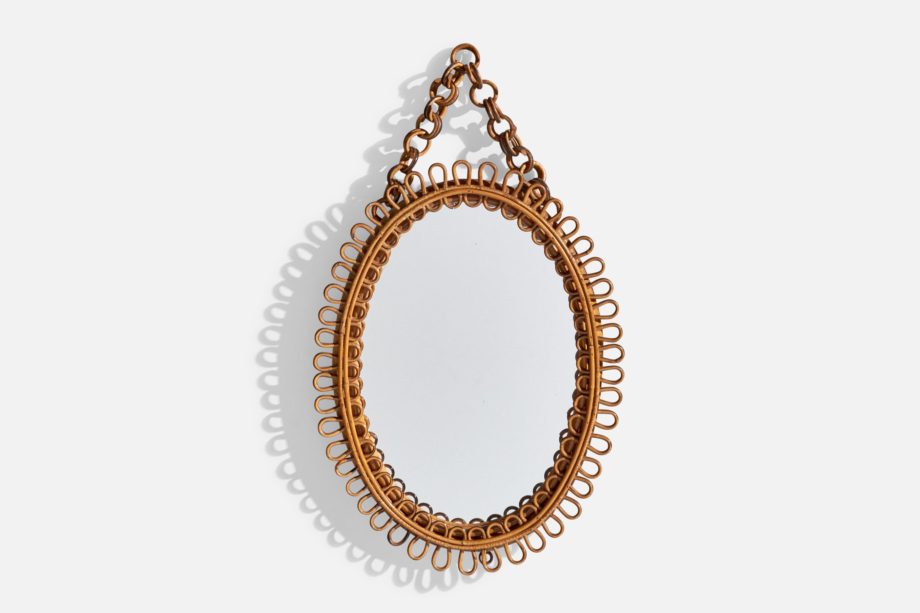 A rattan and bamboo wall mirror designed and produced by an Italian Designer, 1960s.