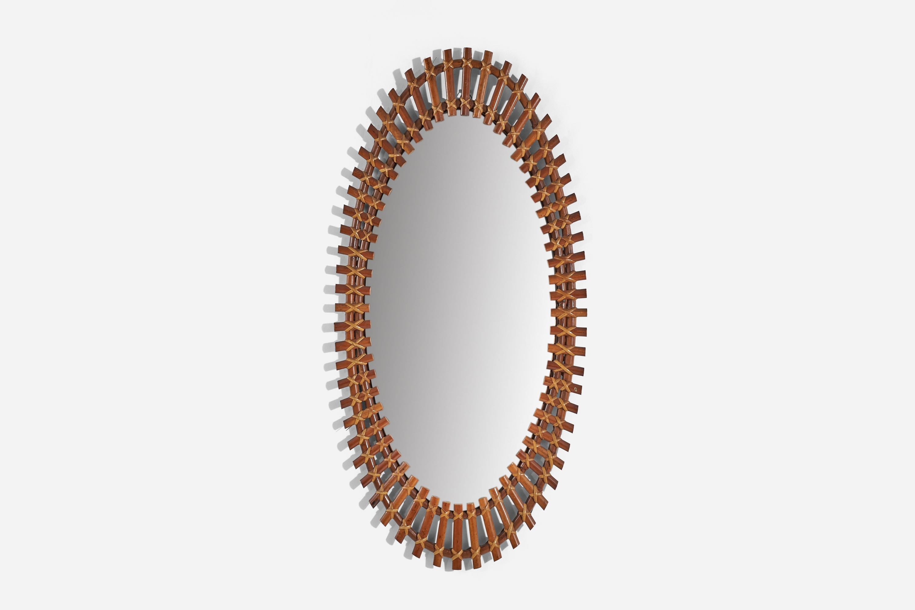 A bamboo and rattan wall mirror designed and produced in Italy, 1960s.