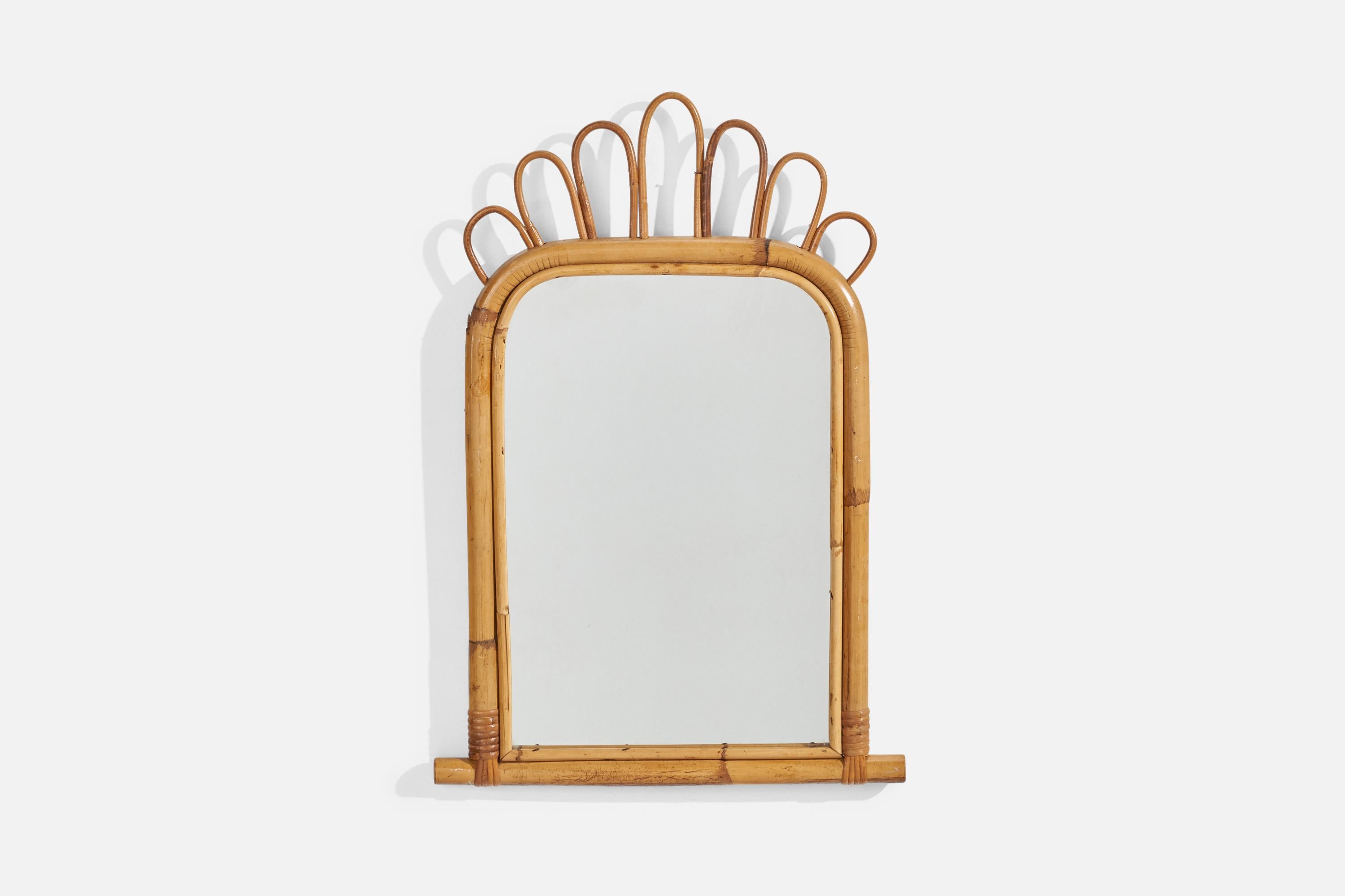 A rattan and bamboo wall mirror designed and produced by an Italian designer, Italy, c. 1960s.
  