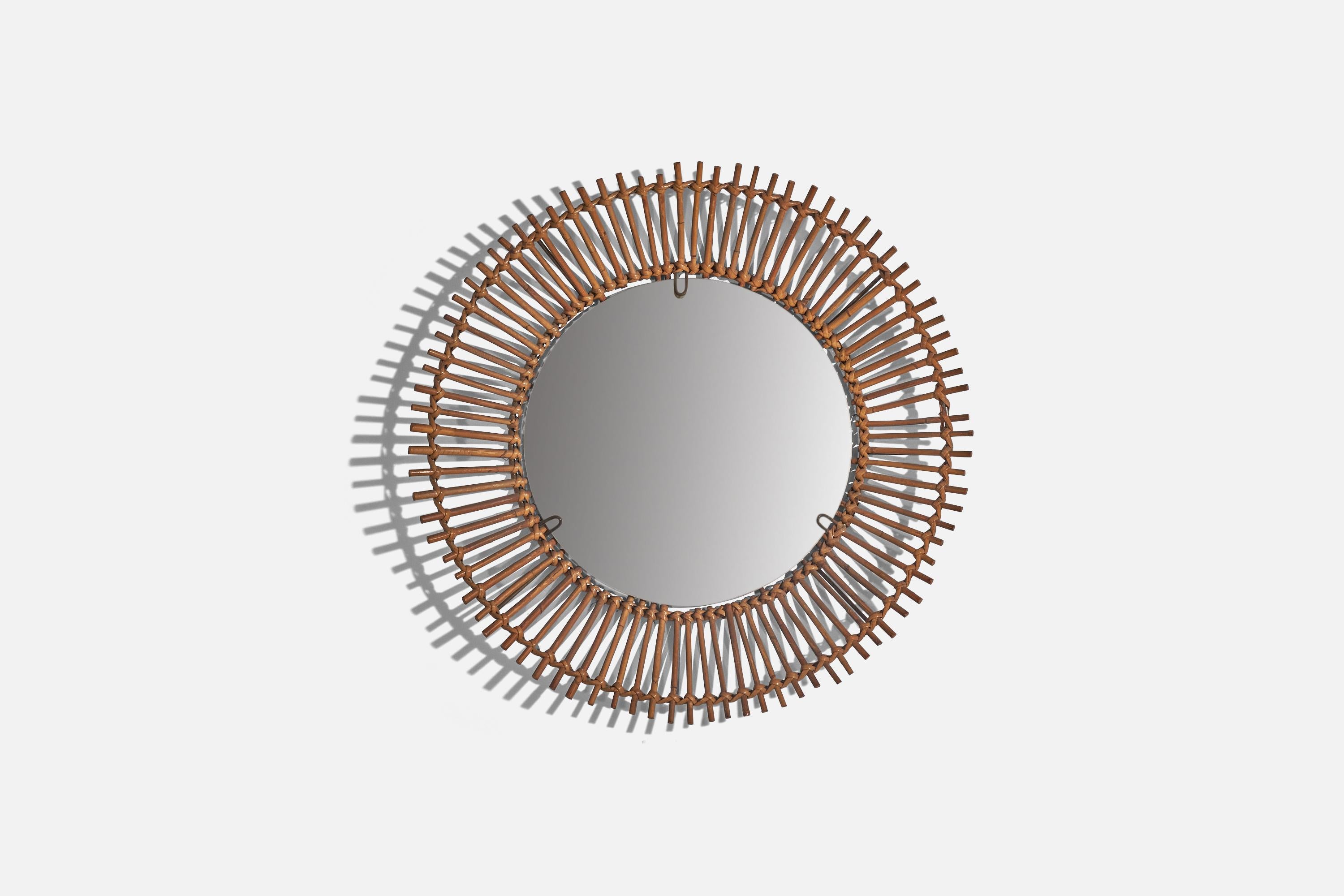 A rattan wall mirror designed and produced by an Italian designer, Italy, c. 1960s.
 