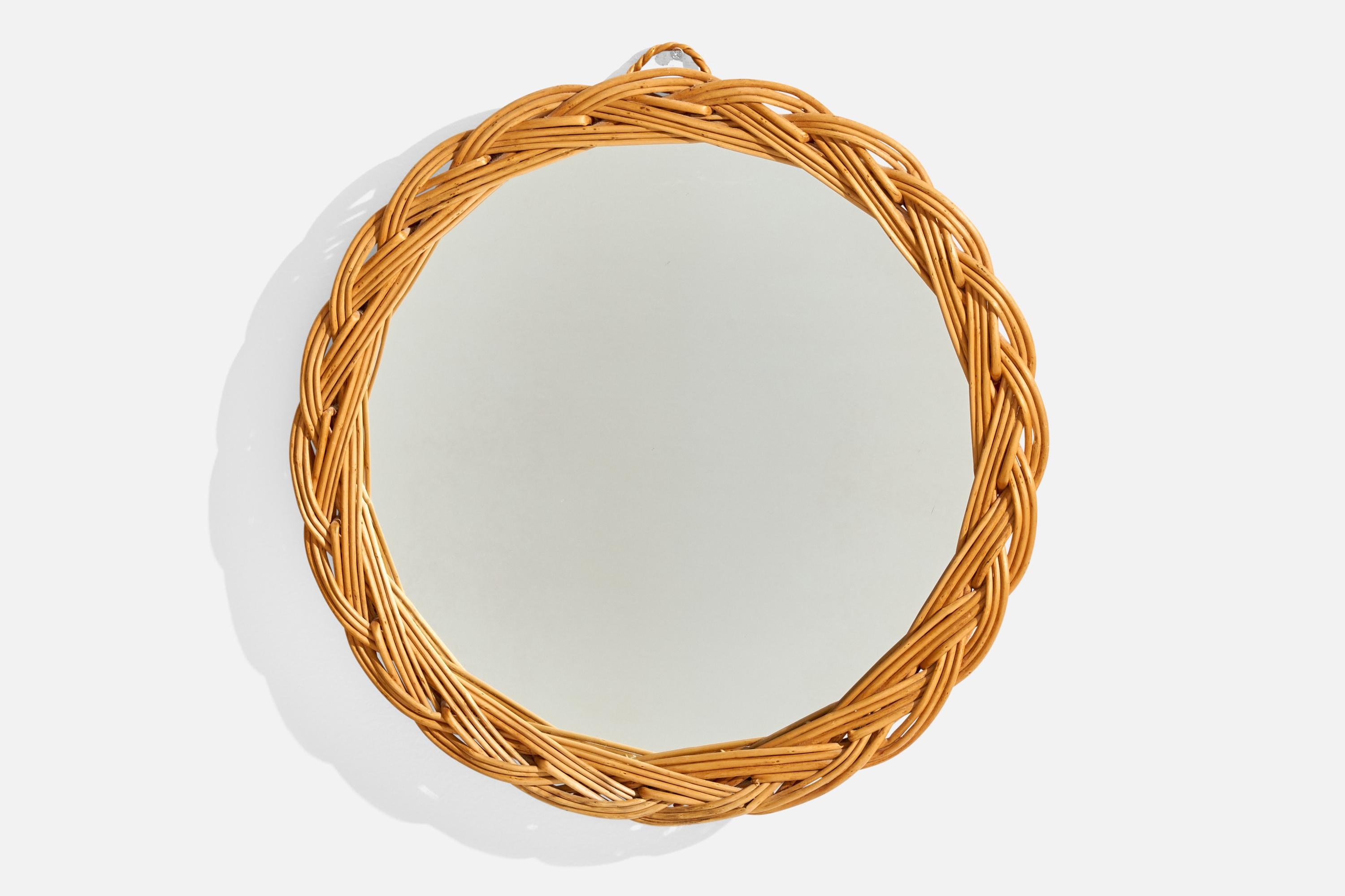 A woven rattan wall mirror designed and produced in Italy, c. 1960s.

Overall Dimensions (inches): 14” Diameter x  1.5” Depth
Does not include mounting hardware.
