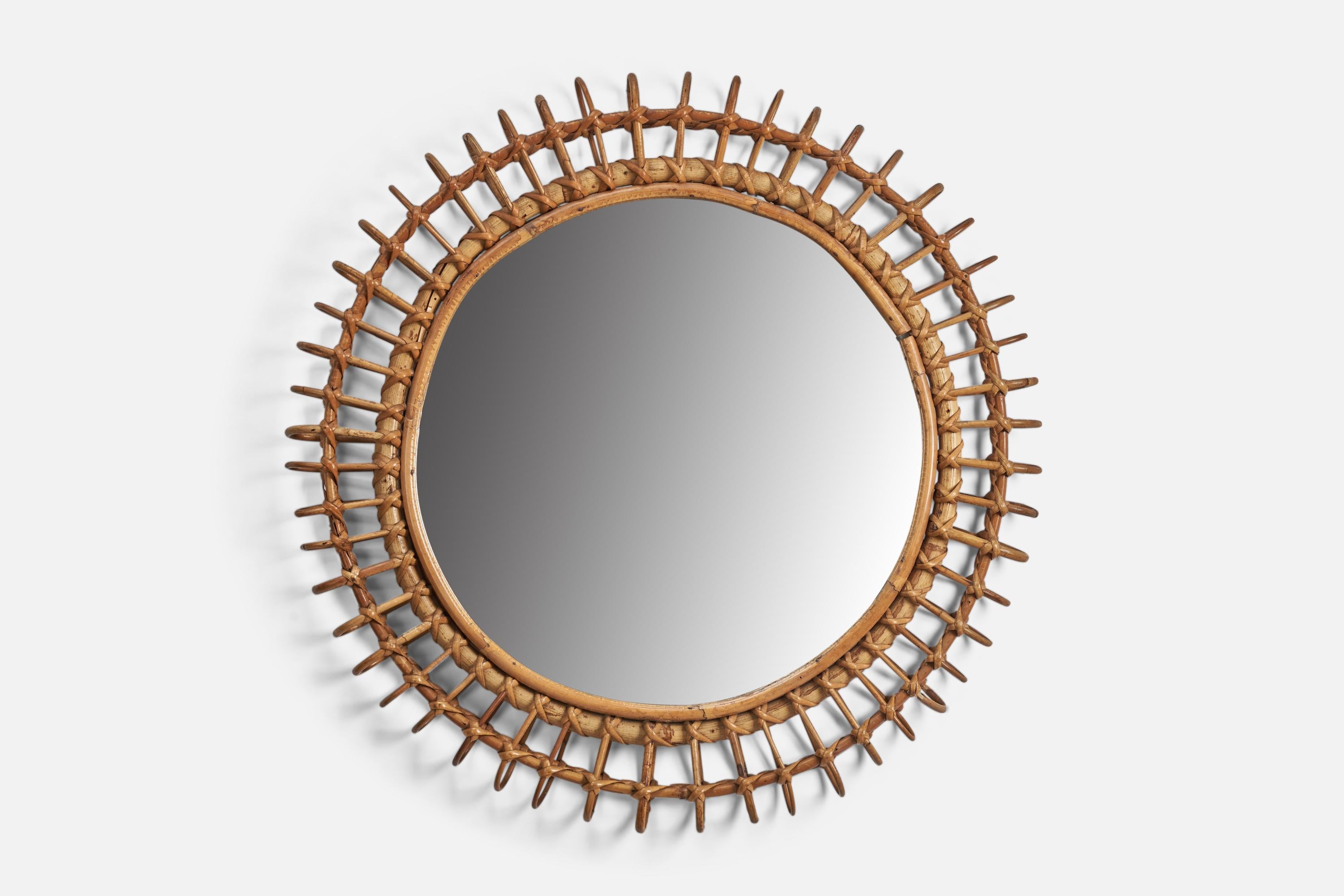 A rattan, glass wall mirror designed and produced by a Italian Designer, Italy, 1960s.