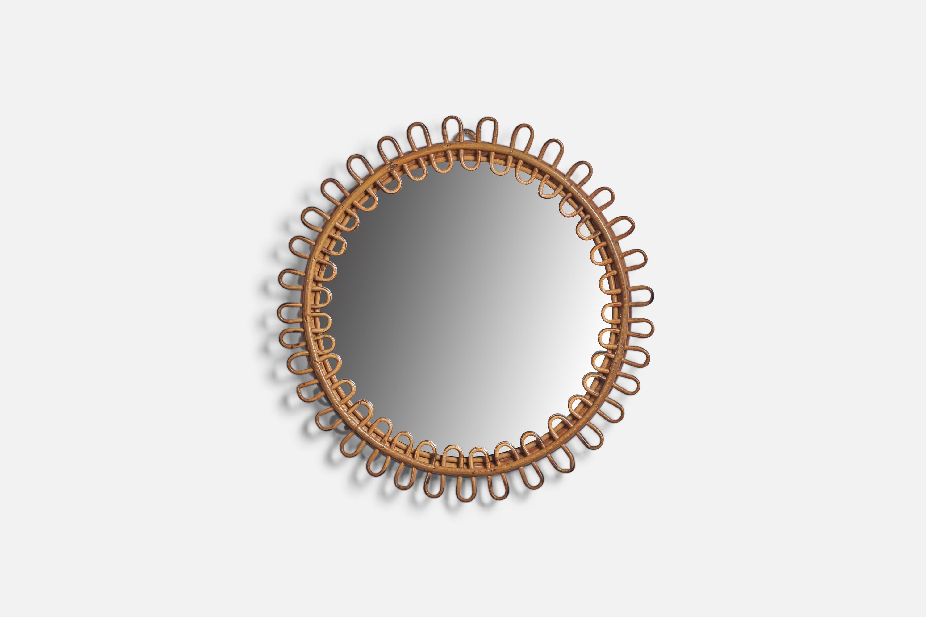 A round rattan wall mirror designed and produced in Italy, 1950s.
