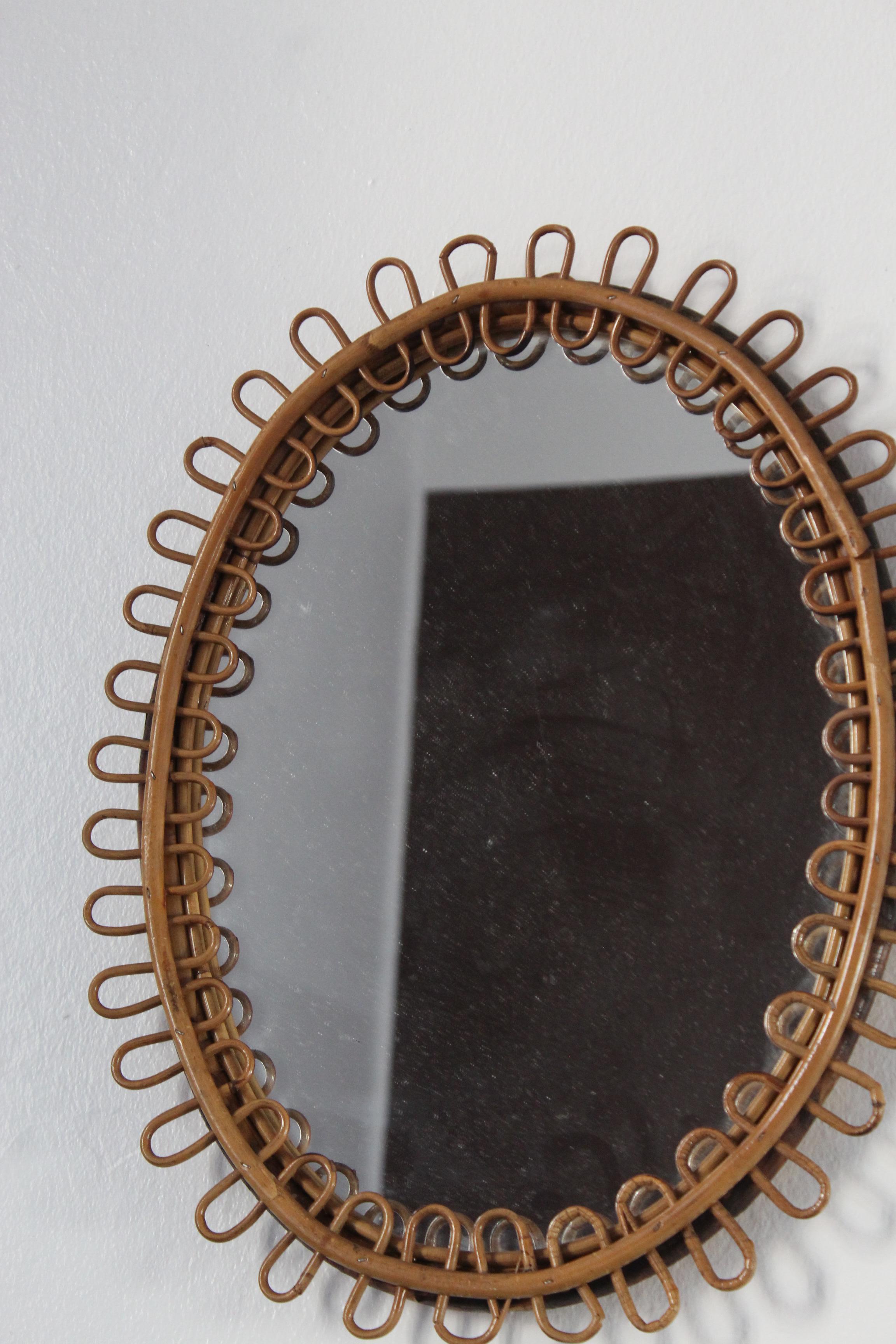 A wall mirror, produced in Italy, 1950s. Cut mirror glass is framed in bamboo and rattan.

Other designers of the period include Gio Ponti, Fontana Arte, Max Ingrand, Franco Albini, and Josef Frank.