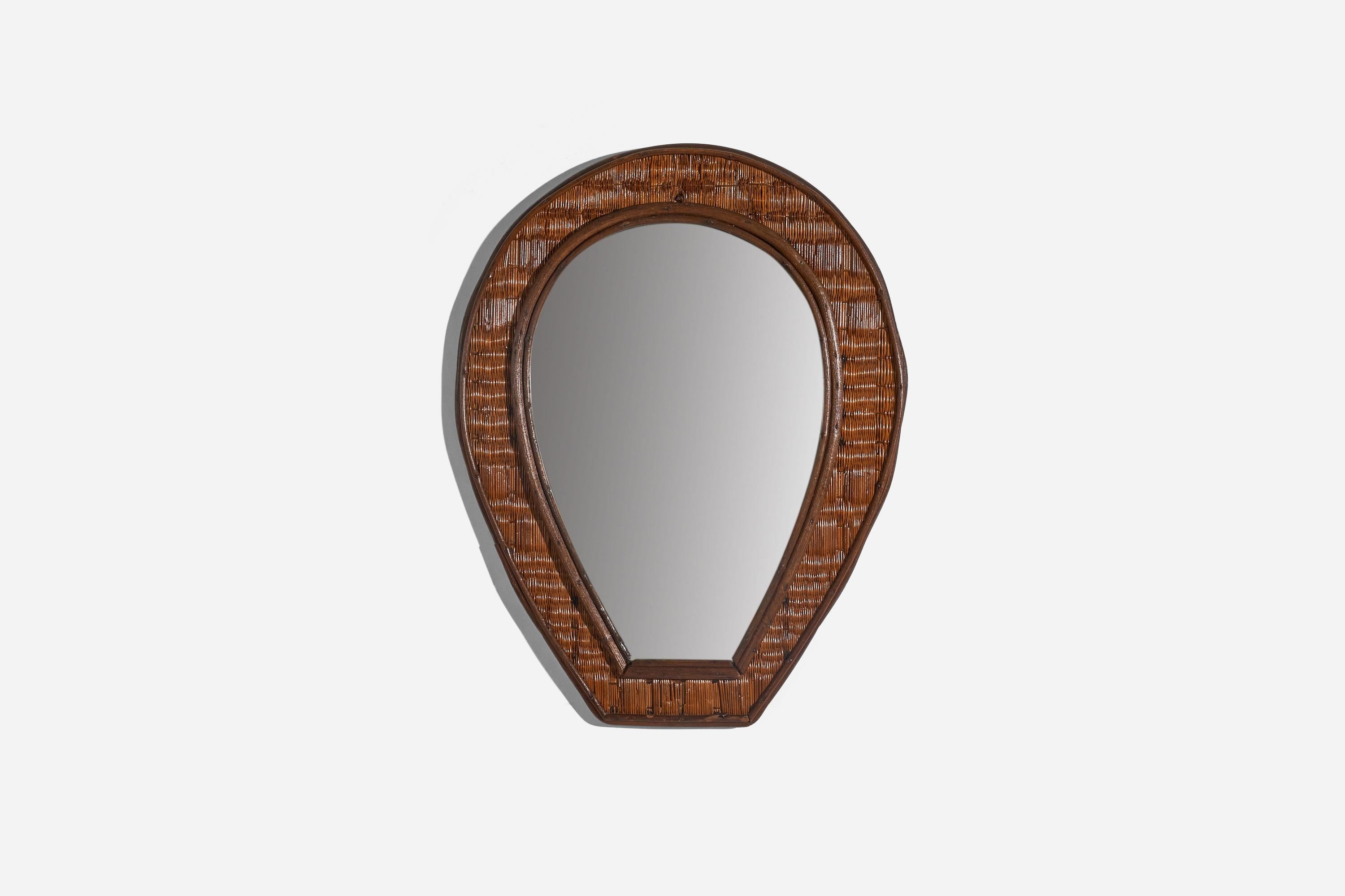 A rattan wall mirror designed and produced by an Italian designer, Italy, c. 1940s.
  