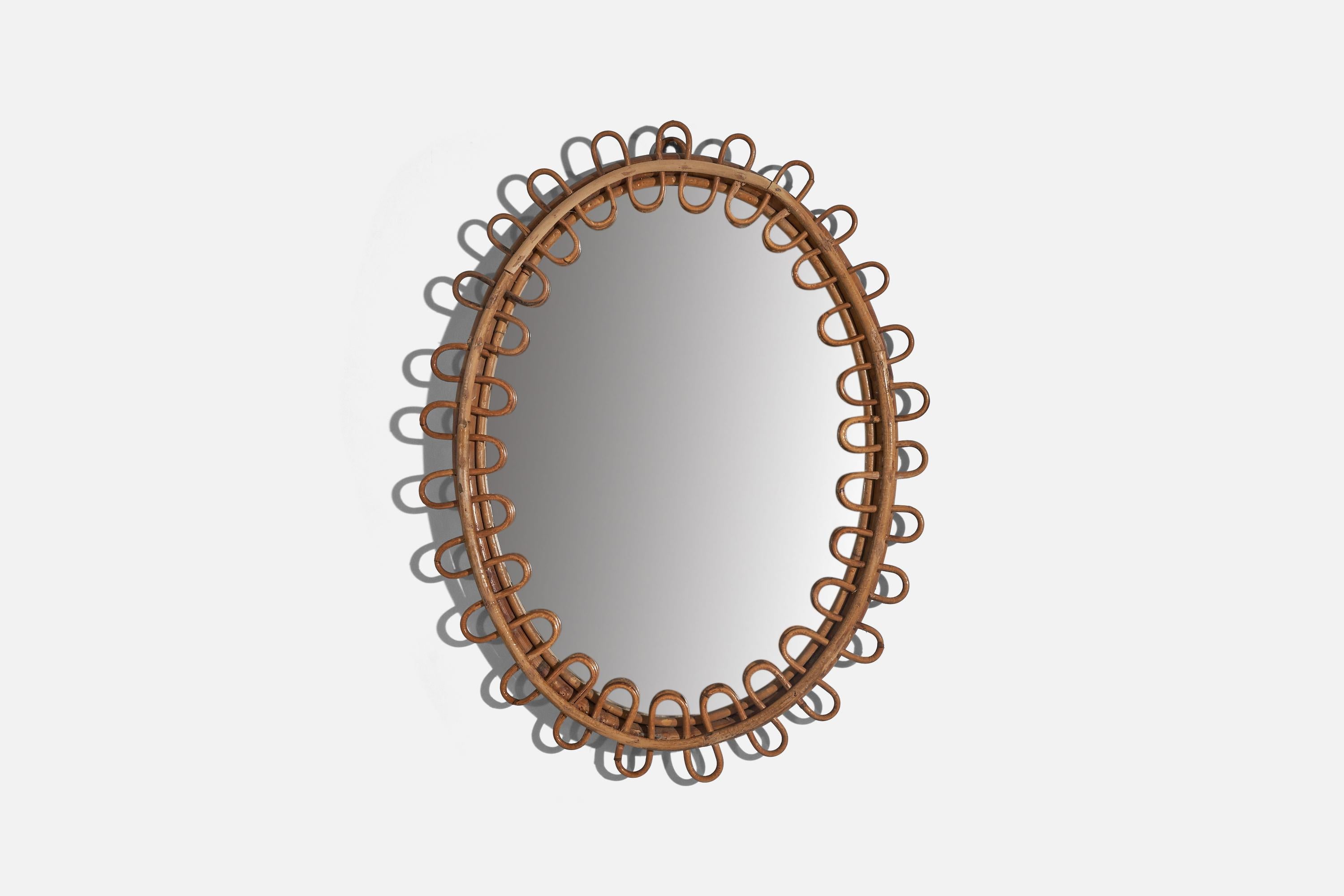 A rattan wall mirror designed and produced by an Italian designer, Italy, c. 1960s.
  