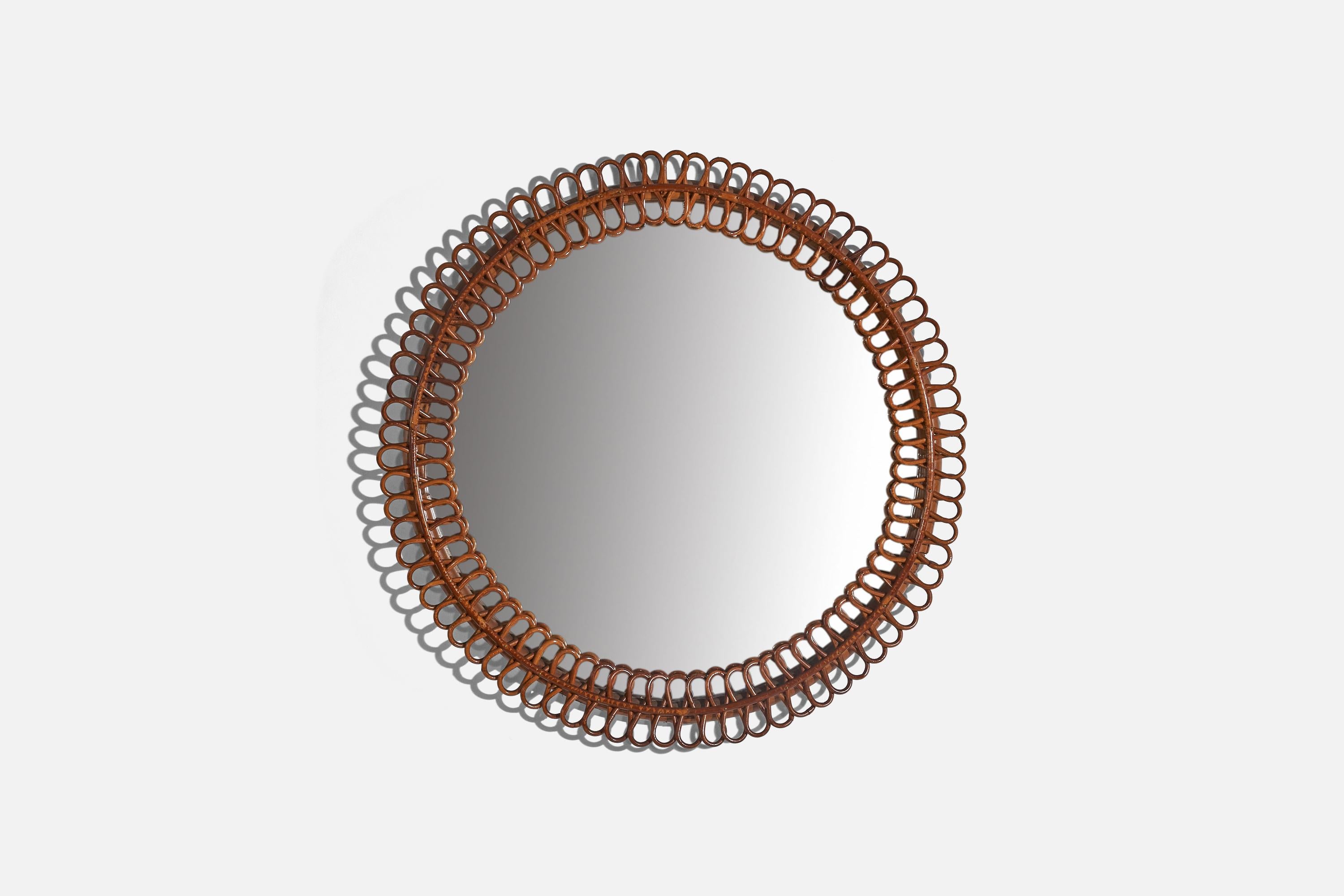 A rattan wall mirror designed and produced by an Italian designer, Italy, c. 1960s.
  