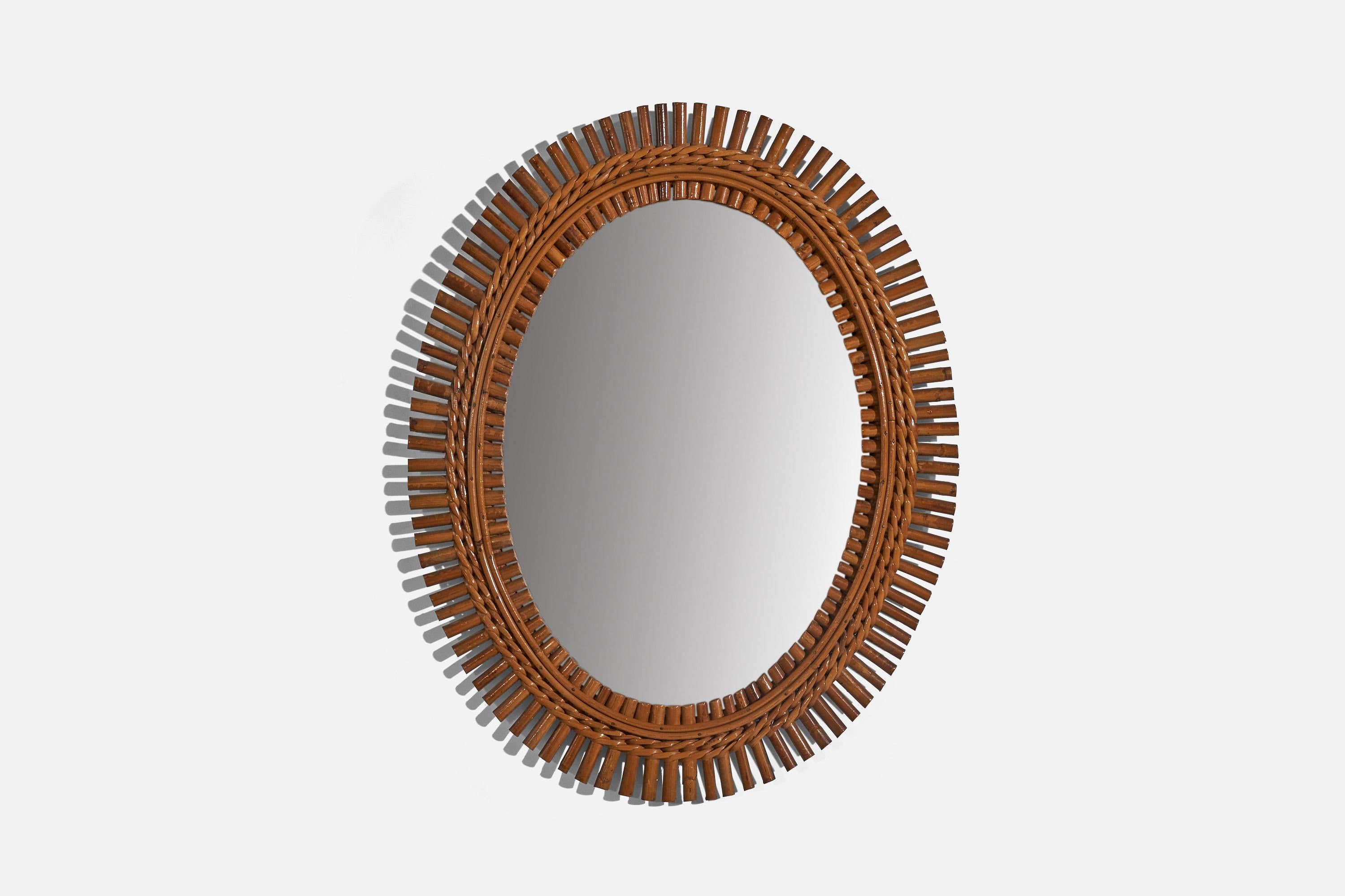 A rattan wall mirror designed and produced by an Italian designer, Italy, c. 1960s.
  