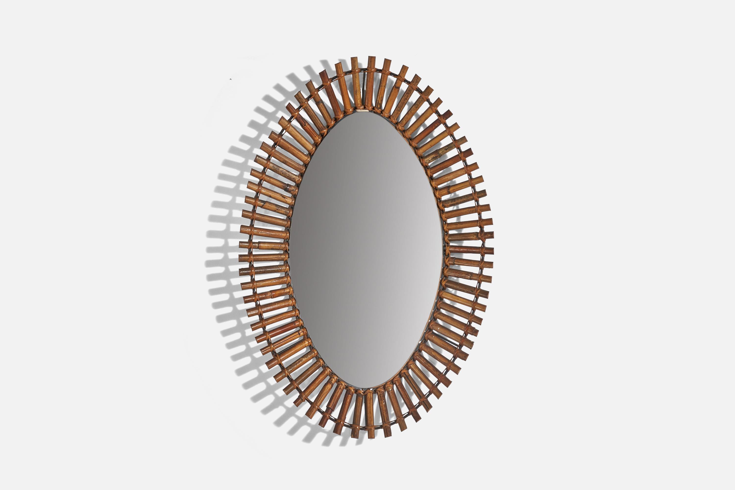 A rattan wall mirror designed and produced by an Italian designer, Italy, c. 1960s.
  