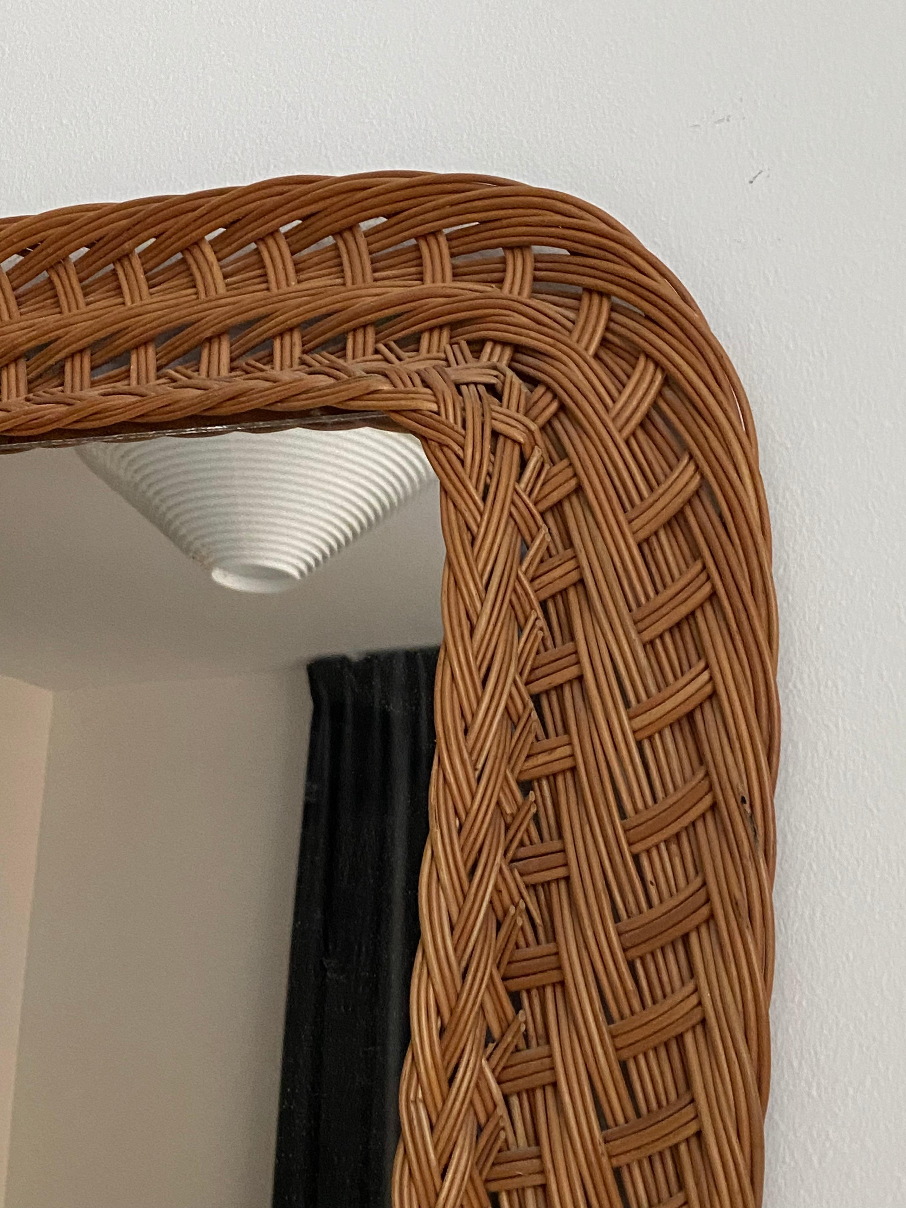 A wall mirror, produced in Italy, c. 1970s. Cut mirror glass is framed in rattan. Unmarked

Other designers of the period include Gio Ponti, Fontana Arte, Max Ingrand, Franco Albini, and Josef Frank.