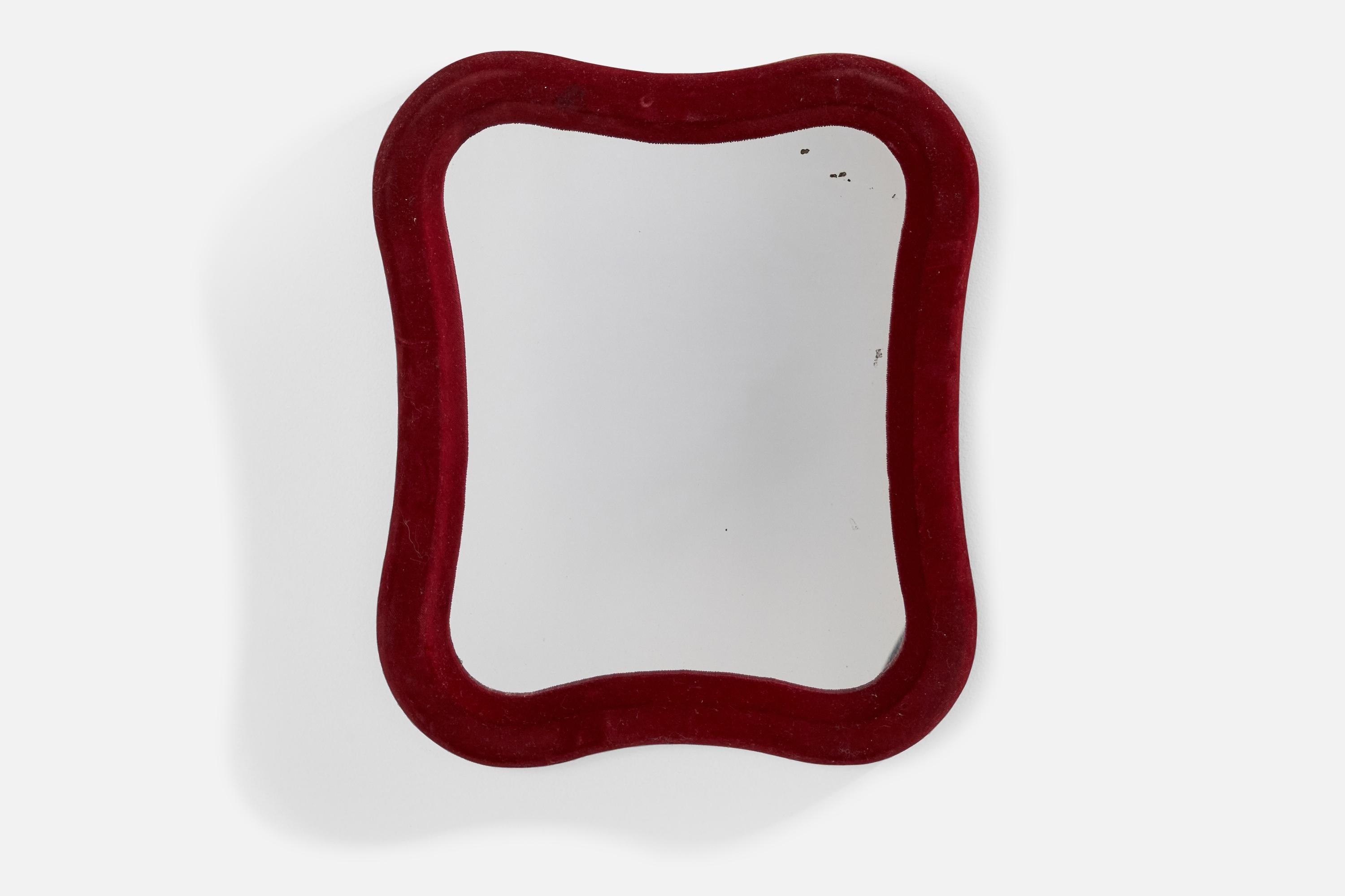A red velvet wall mirror designed and produced in Italy, 1970s.