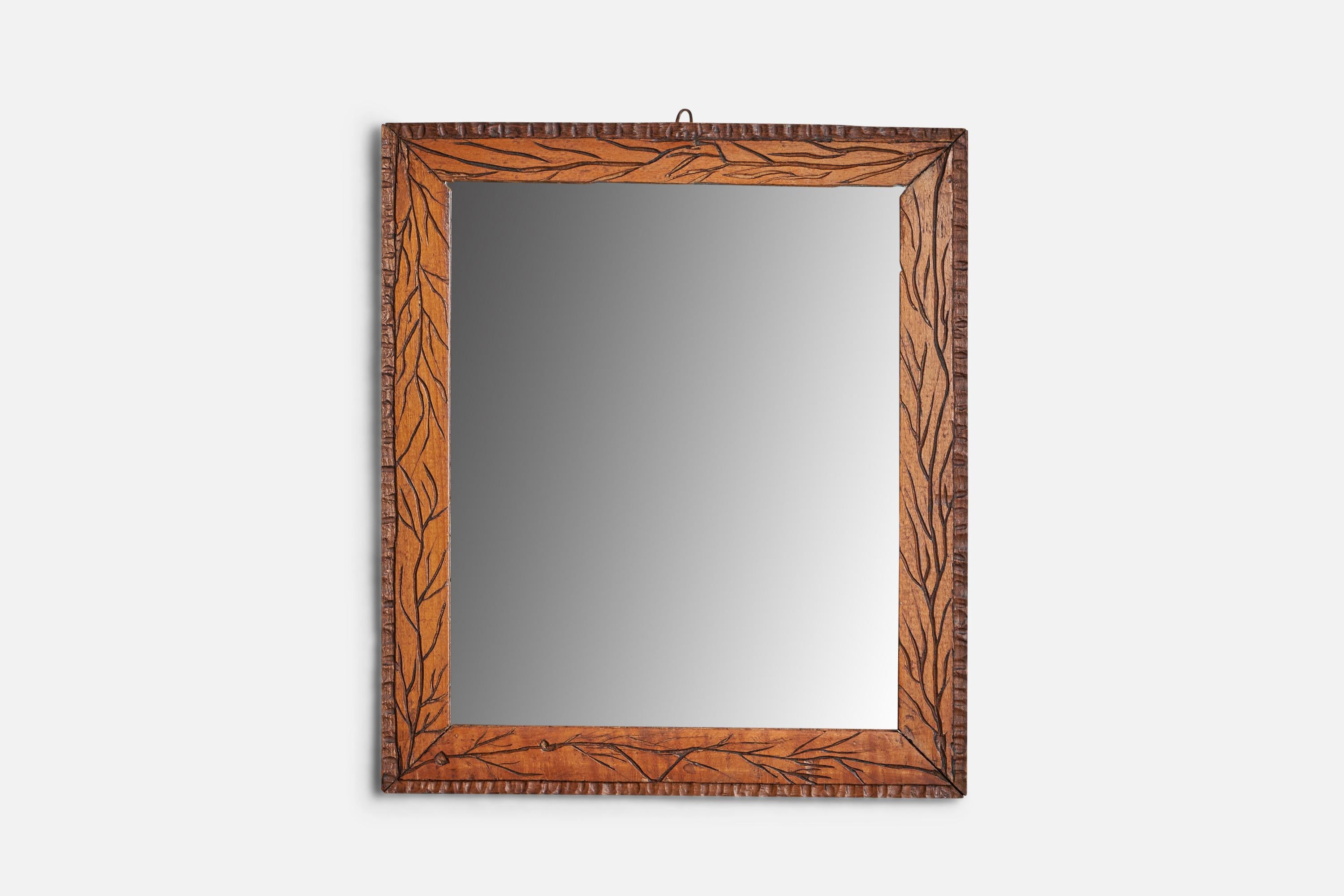 A carved wood wall mirror designed and produced in Italy, 1930s.