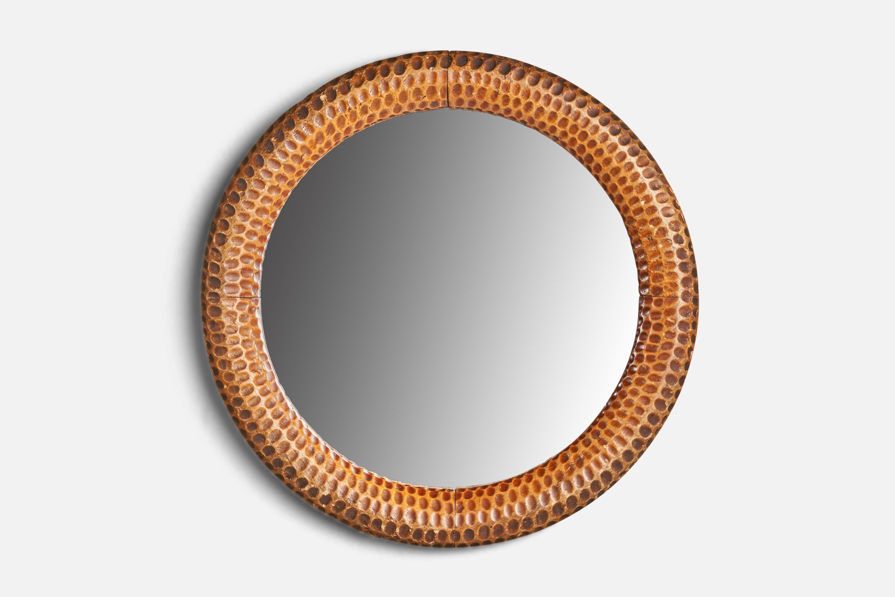 A carved and burnished wood wall mirror designed and produced in Italy, 1940s.