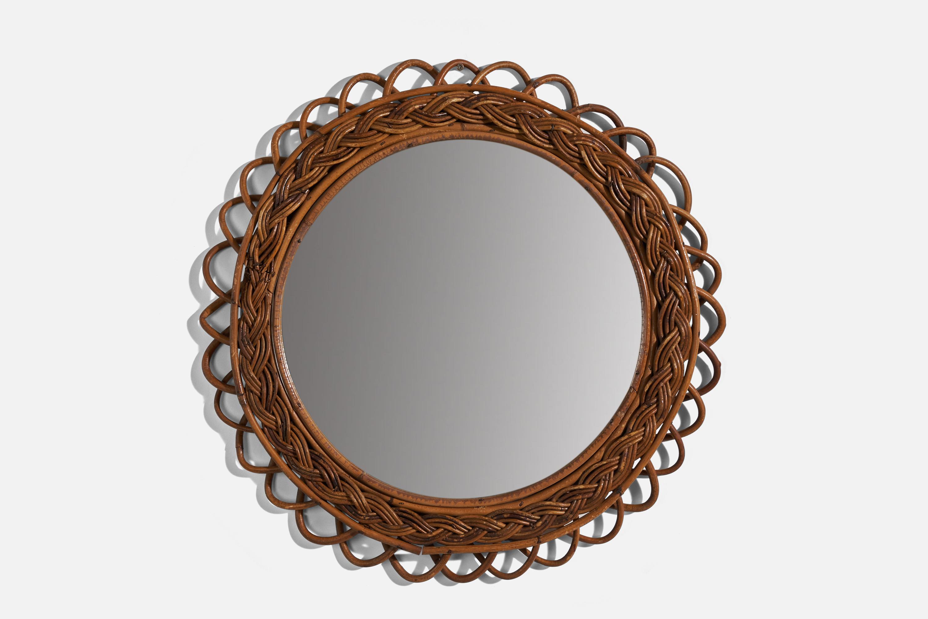 A woven rattan wall mirror designed and produced in Italy, 1950s. 